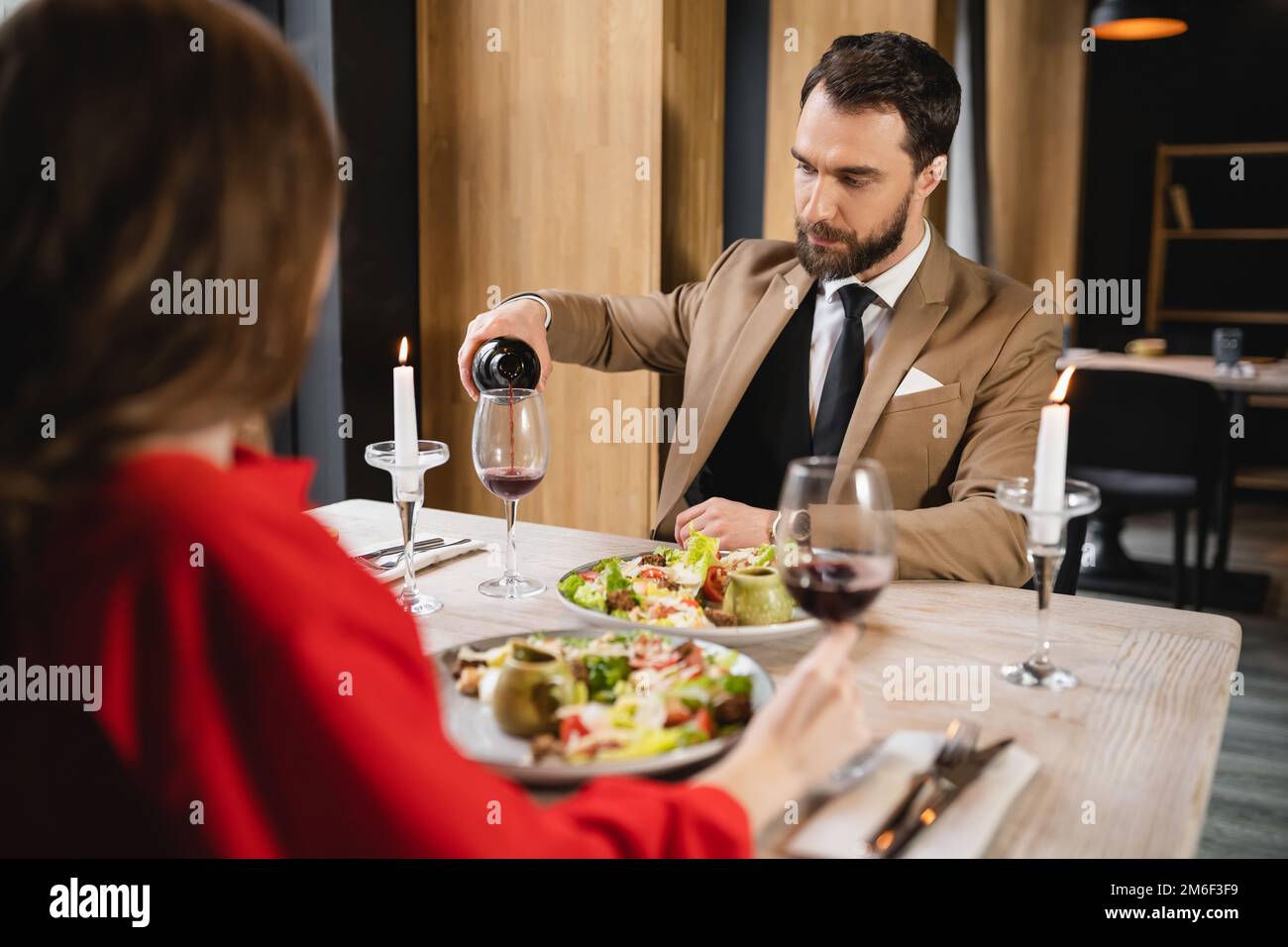 man hold wine glass, bearded guy in office style clothes at restaurant,  sommelier near woman in mirror Stock Photo - Alamy