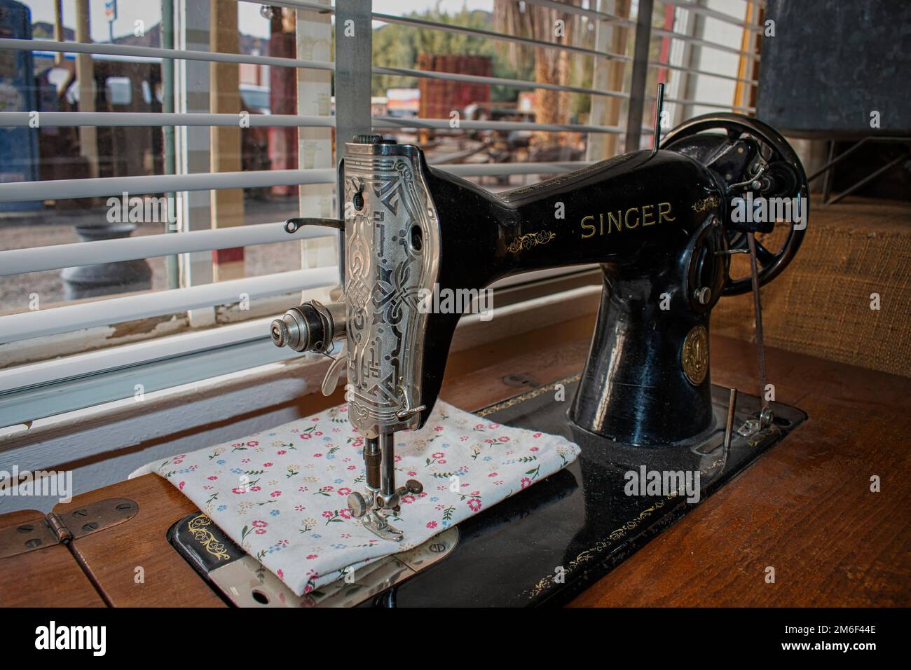 An Old Singer sewing machine near a window Stock Photo