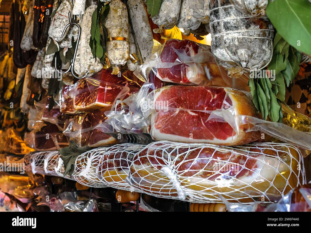 Stacks of drycured sausages, Parma ham, and prosciutto French