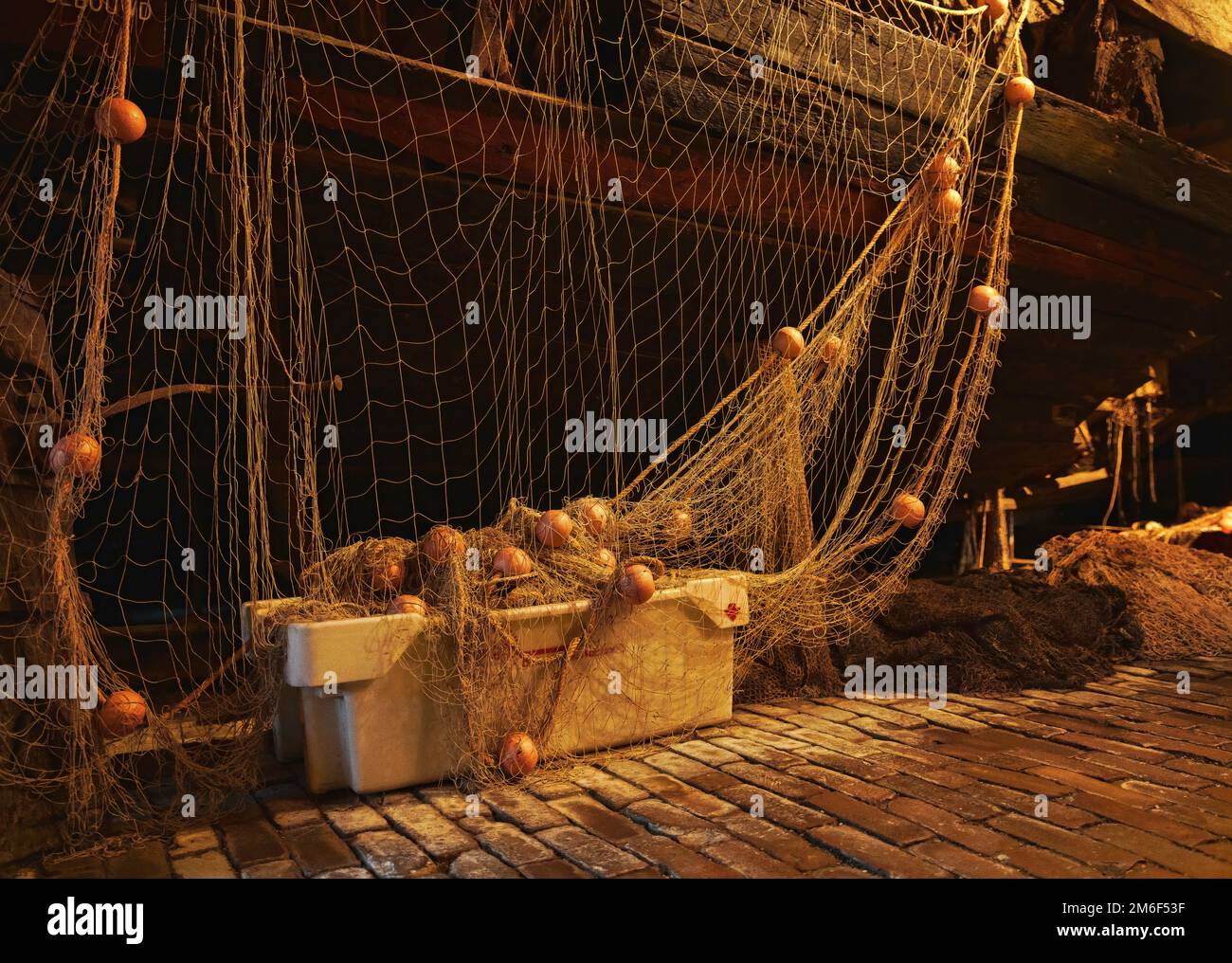 https://c8.alamy.com/comp/2M6F53F/fishing-nets-with-floats-for-a-wooden-ship-2M6F53F.jpg