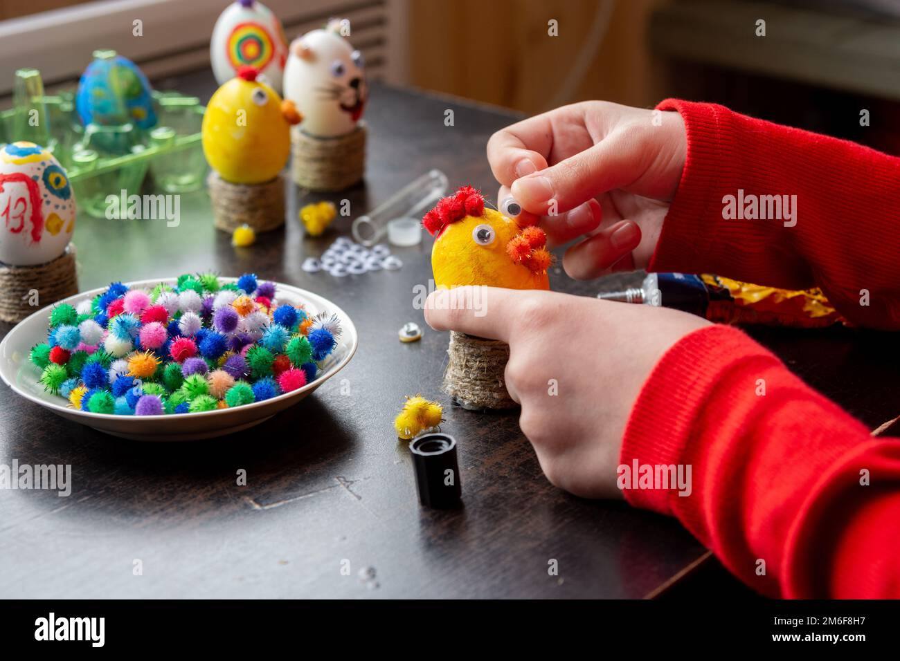 A child makes a gift egg for the Easter holiday Stock Photo