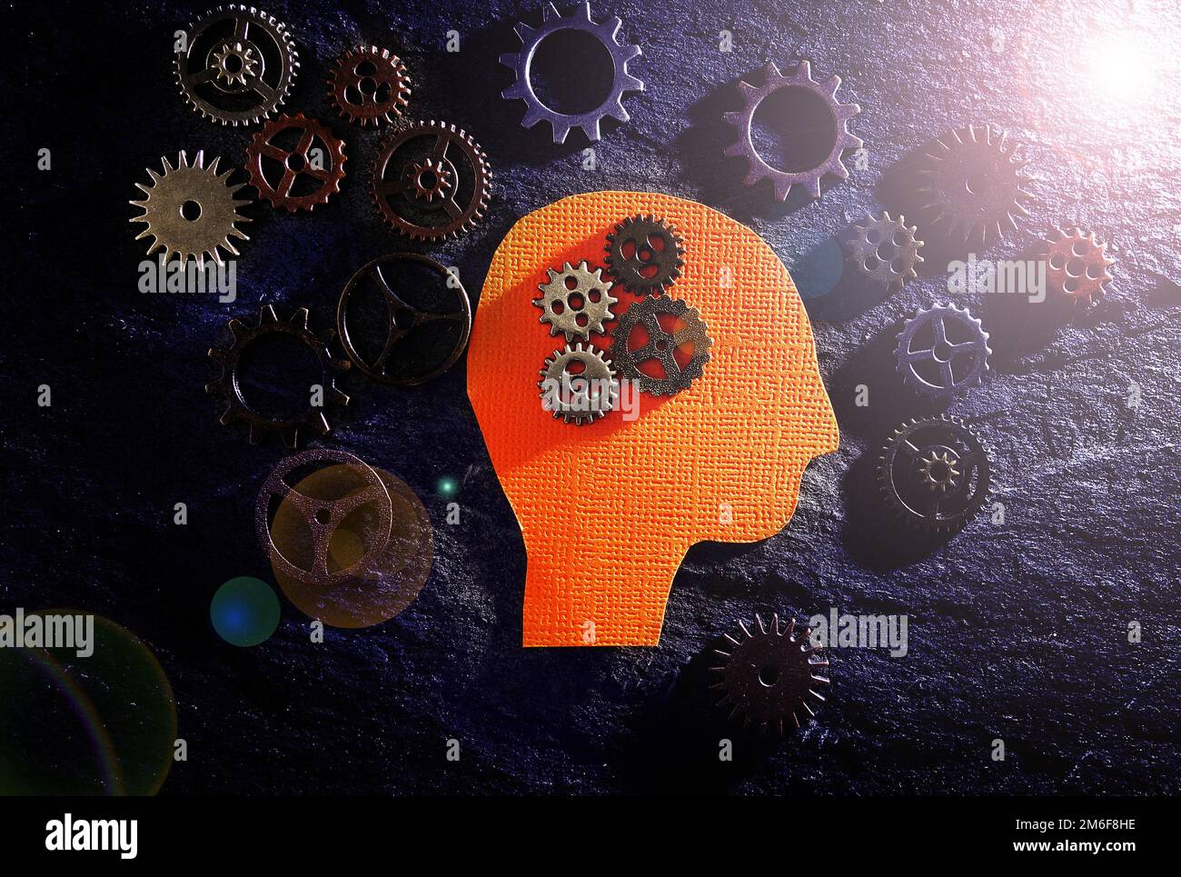 Head figure with gears on textured surface - science or technology background Stock Photo