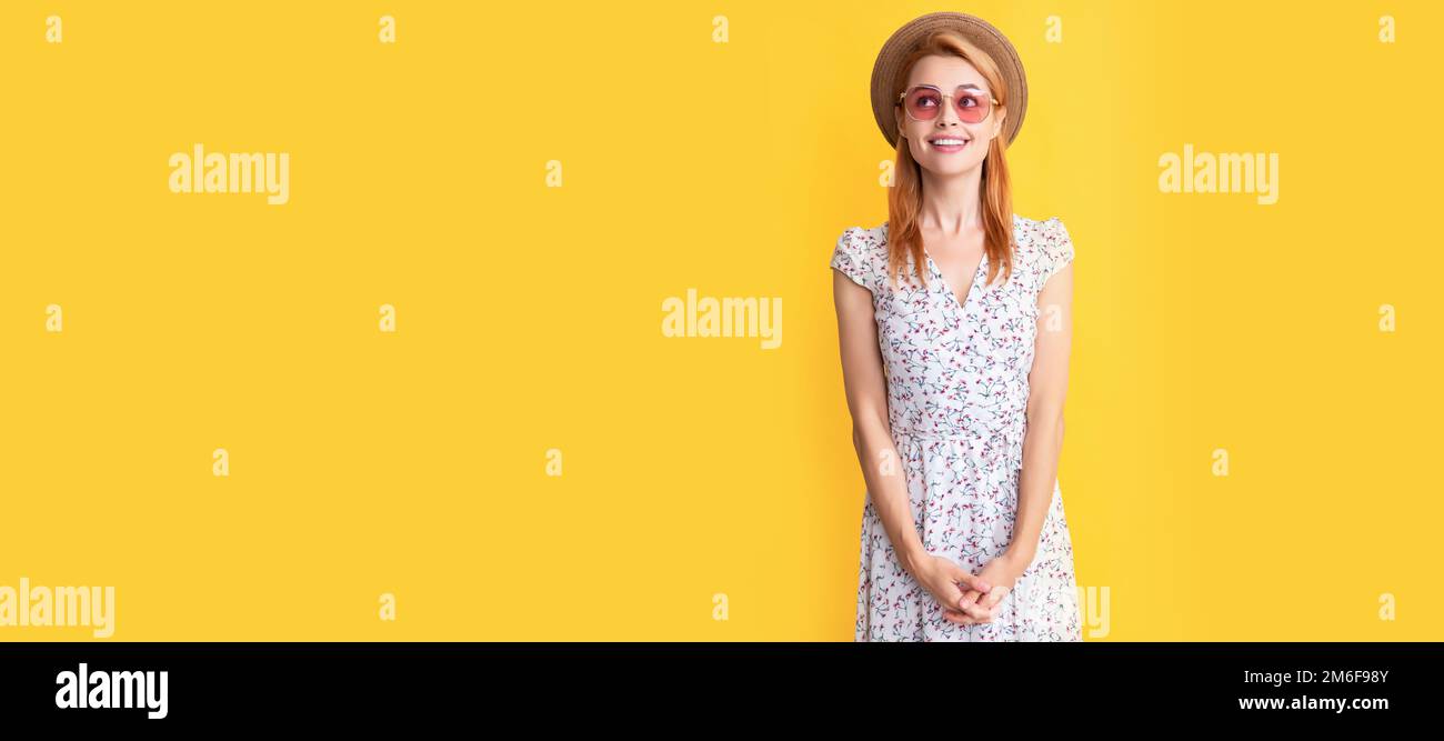 happy young woman in straw hat and sunglasses on yellow background ...