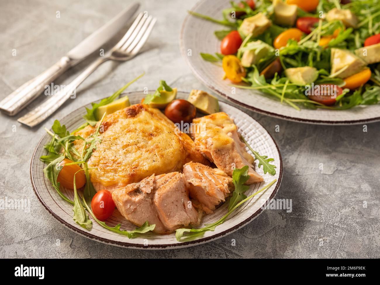 Salmon baked with cheese, served with vegetables. Stock Photo