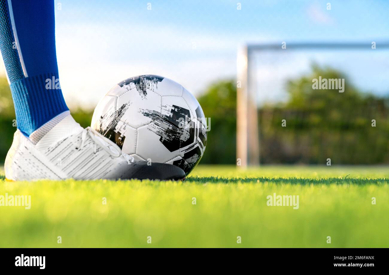 professional football or soccer player kick and shoot ball at penalty or  freekick to goalkeeper for winning champion goal in final match league in  fie Stock Photo - Alamy