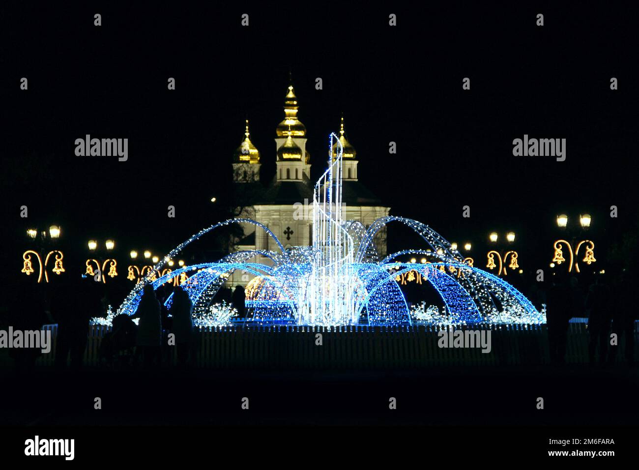 Beautiful fountains in city park. Colorful fountains from garlands. Christmas and New Year's winter Stock Photo