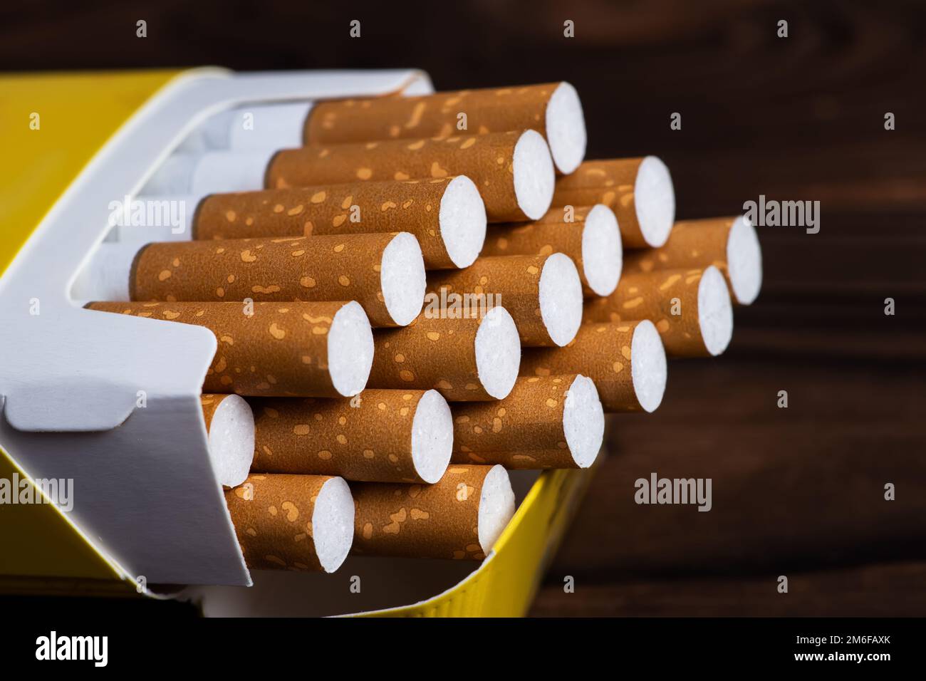 Cigarettes in a pack. Yellow filter. Harm to health. Bad habit. A pack