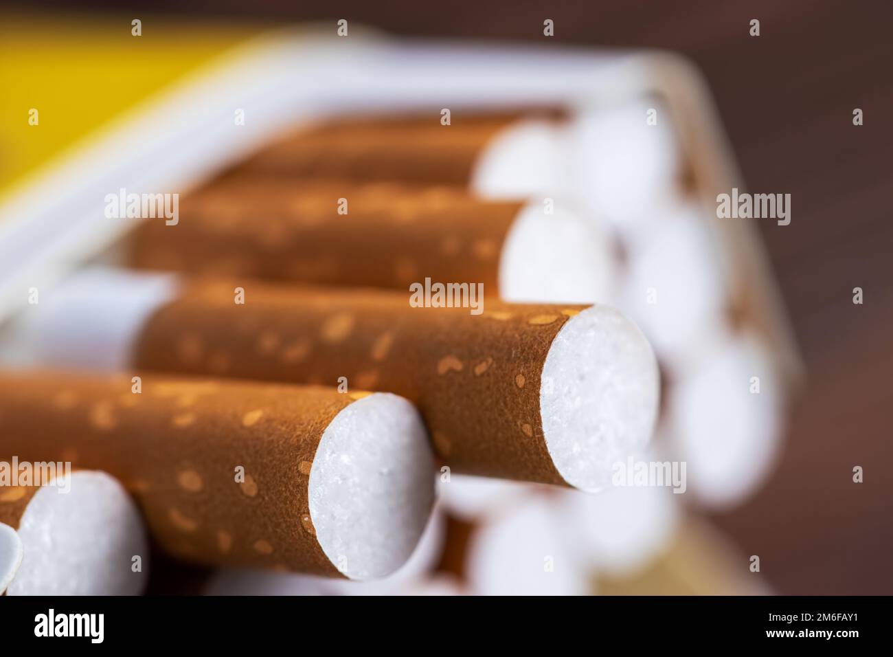 Cigarettes in a pack. Yellow filter. Harm to health. Bad habit. A pack
