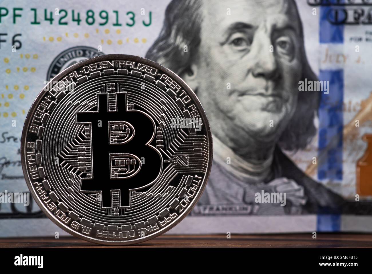 Money equivalence between bitcoin and dollars. Exchange cryptos. Pile of 100 dollar banknotes