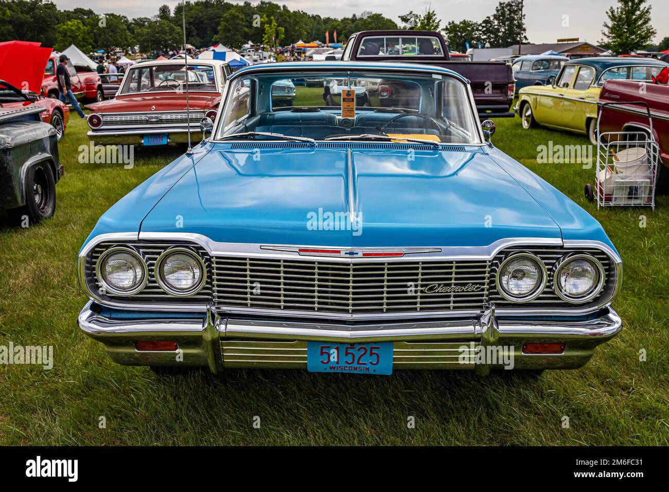 Iola, WI - July 07, 2022: High perspective front view of a 1964 Chevrolet Impala Sport Coupe at a local car show. Stock Photo