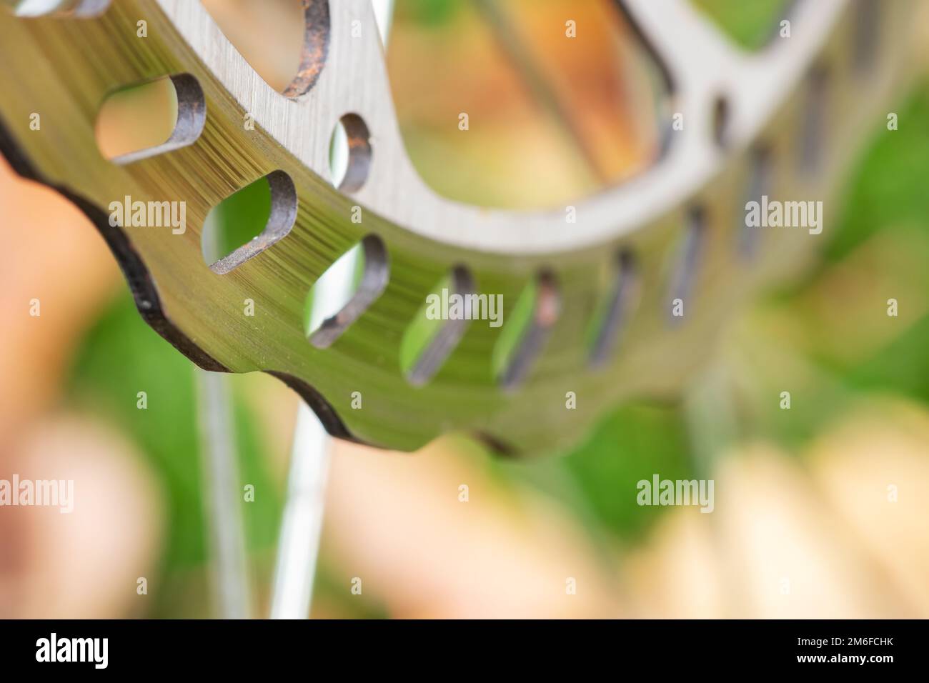 Bicycle disk brakes close up, grey metal disc attached to bike wheel