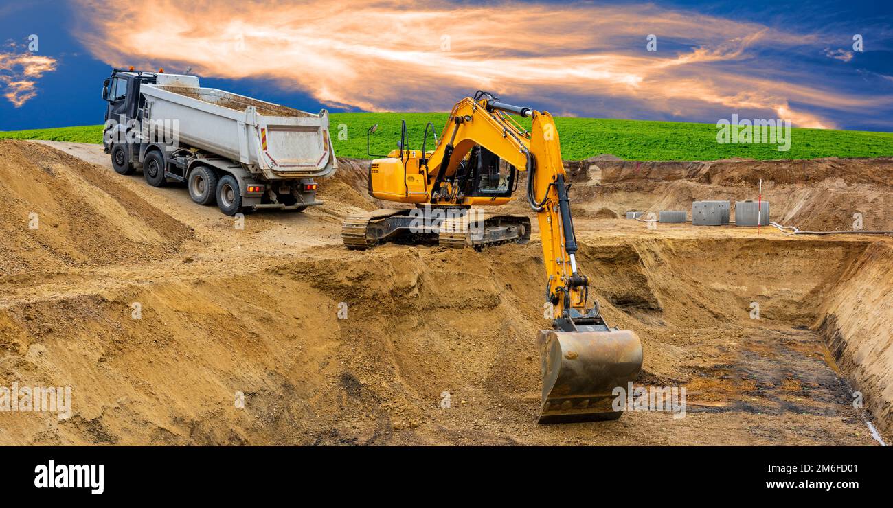 Excavator at work on construction site Stock Photo - Alamy