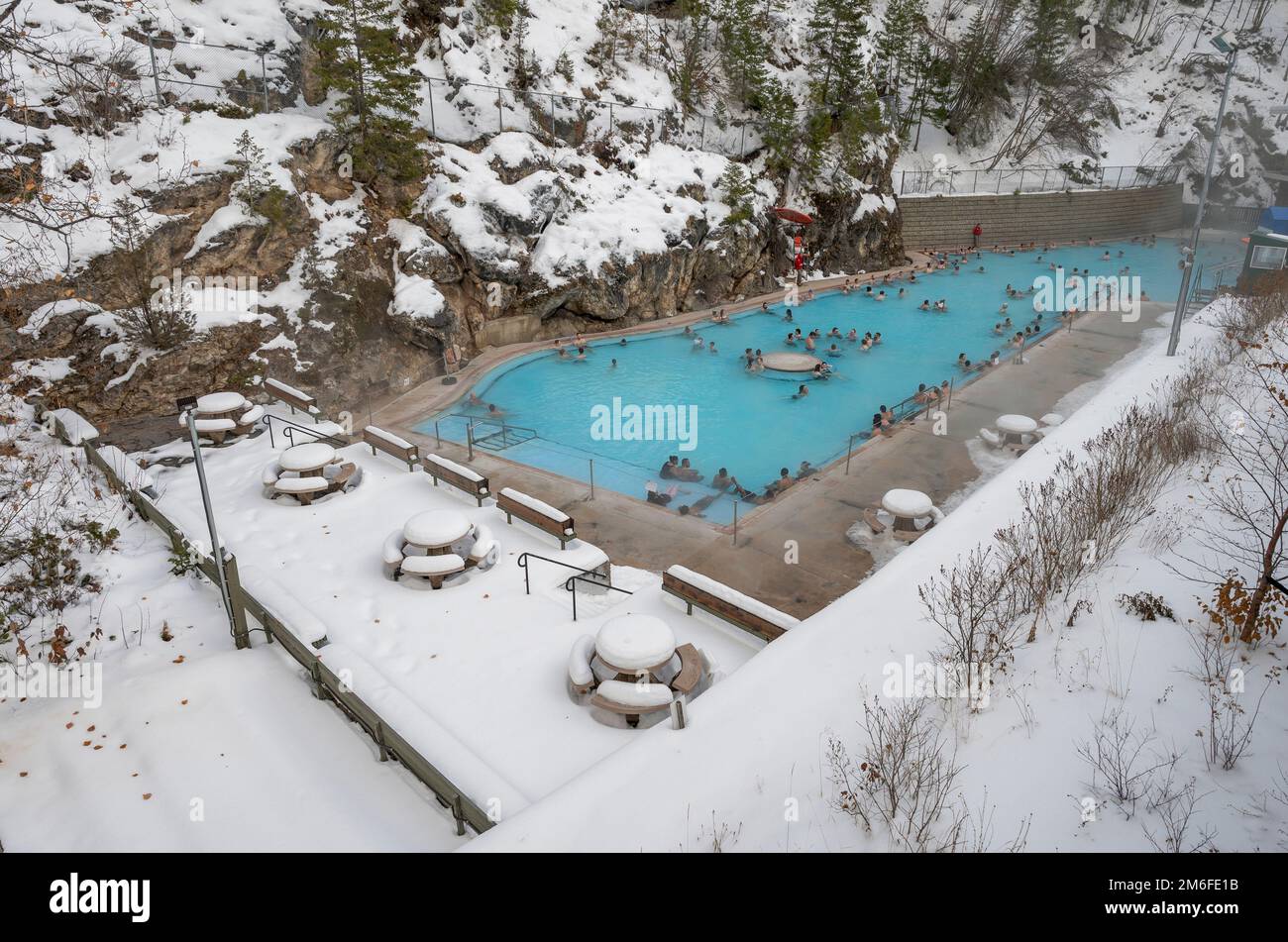 Radium Hot Springs, British Columbia, Canada – January 30, 2022:  People relax in a natural hot spring in Kootenay National Park Stock Photo