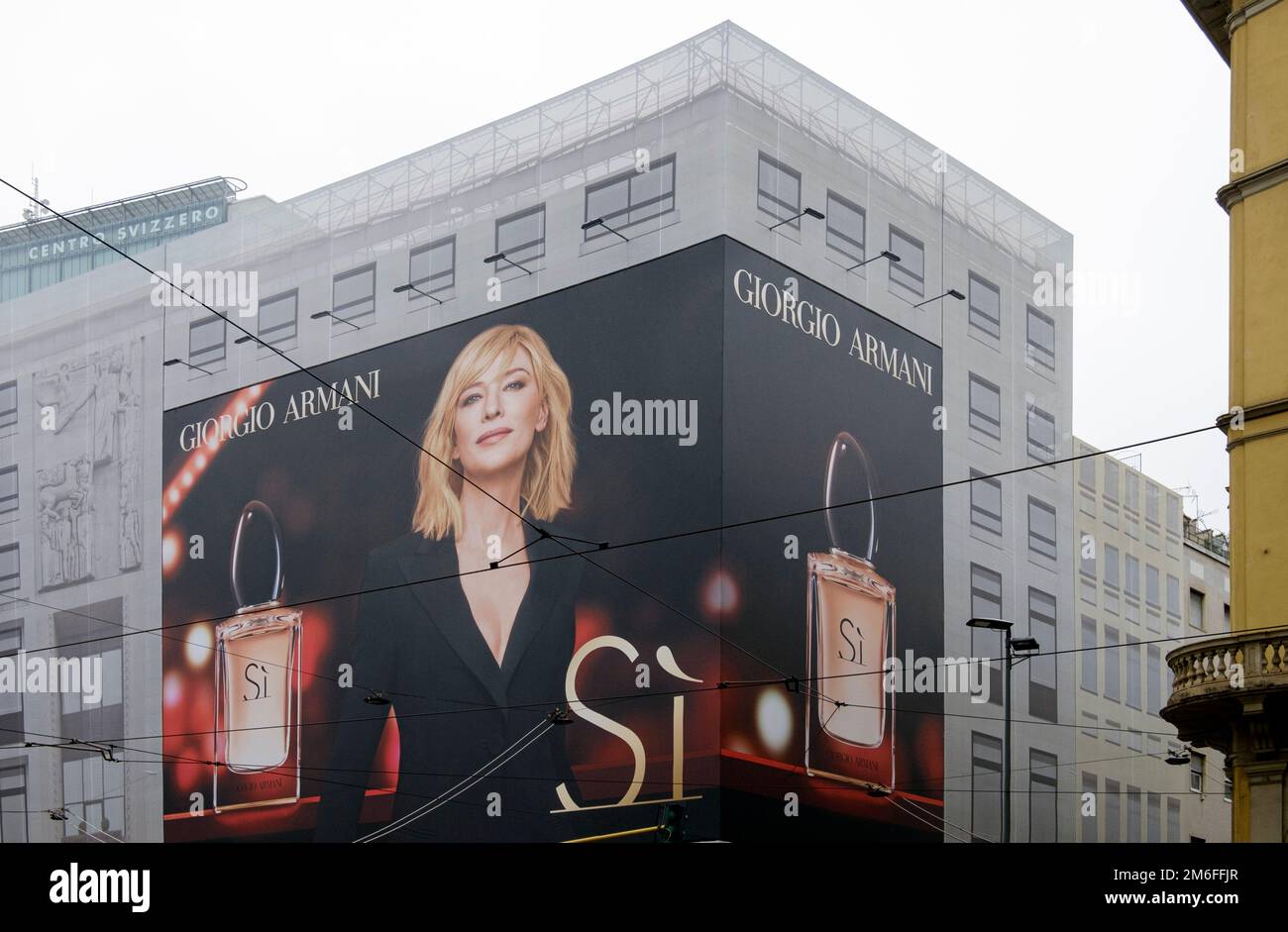 Big advertising billboard with Giorgio Armani perfume displayed on the facade of a building in the center of Milano, Italy Stock Photo