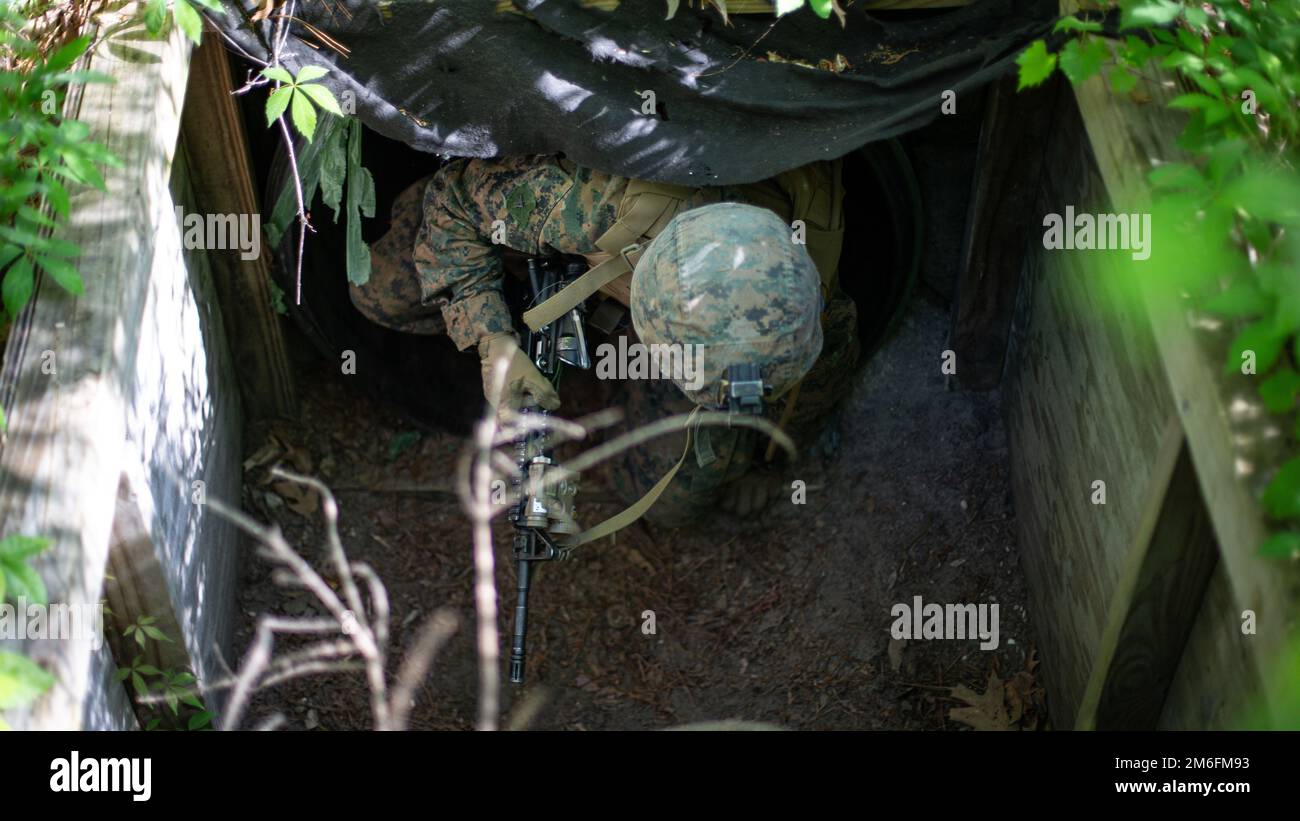 U.S. Marine Corps Pfc. Justin Teague, a Dallastown, Pennsylvania, native and rifleman with 2d Light Armored Reconnaissance Battalion, 2d Marine Division, navigates a tunnel obstacle during a Combat Marksmanship Competition on Camp Lejeune, North Carolina, April 27, 2022. The purpose of this course of fire is to test the limit of the Marines’ shooting capabilities under physical exertion in order to develop proficiency in their individual skills and increase the lethality of the unit. Stock Photo