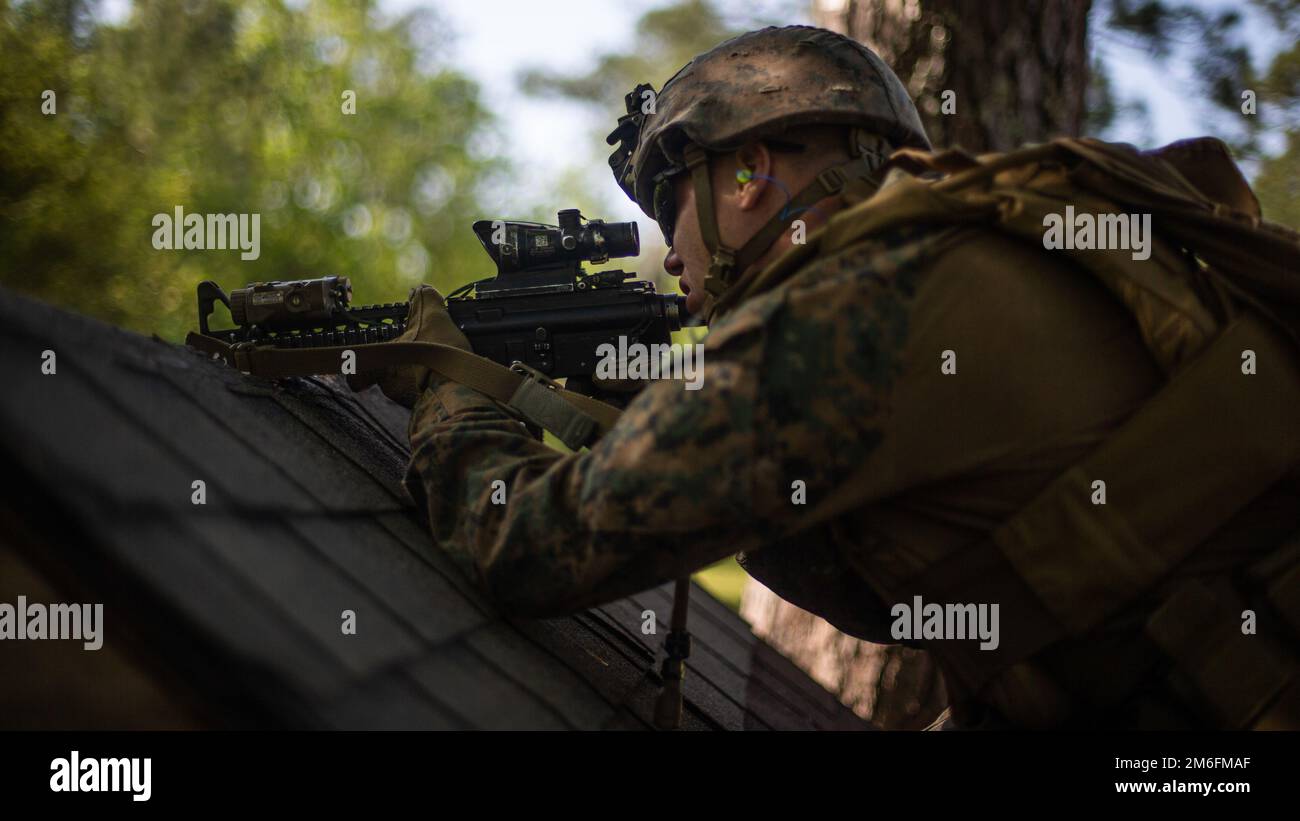 U.S. Marine Corps Pfc. Justin Teague, a Dallastown, Pennsylvania, native and rifleman with 2d Light Armored Reconnaissance Battalion, 2d Marine Division, fires his rifle during a Combat Marksmanship Competition on Camp Lejeune, North Carolina, April 27, 2022. The purpose of this course of fire is to test the limit of the Marines’ shooting capabilities under physical exertion in order to develop proficiency in their individual skills and increase the lethality of the unit. Stock Photo