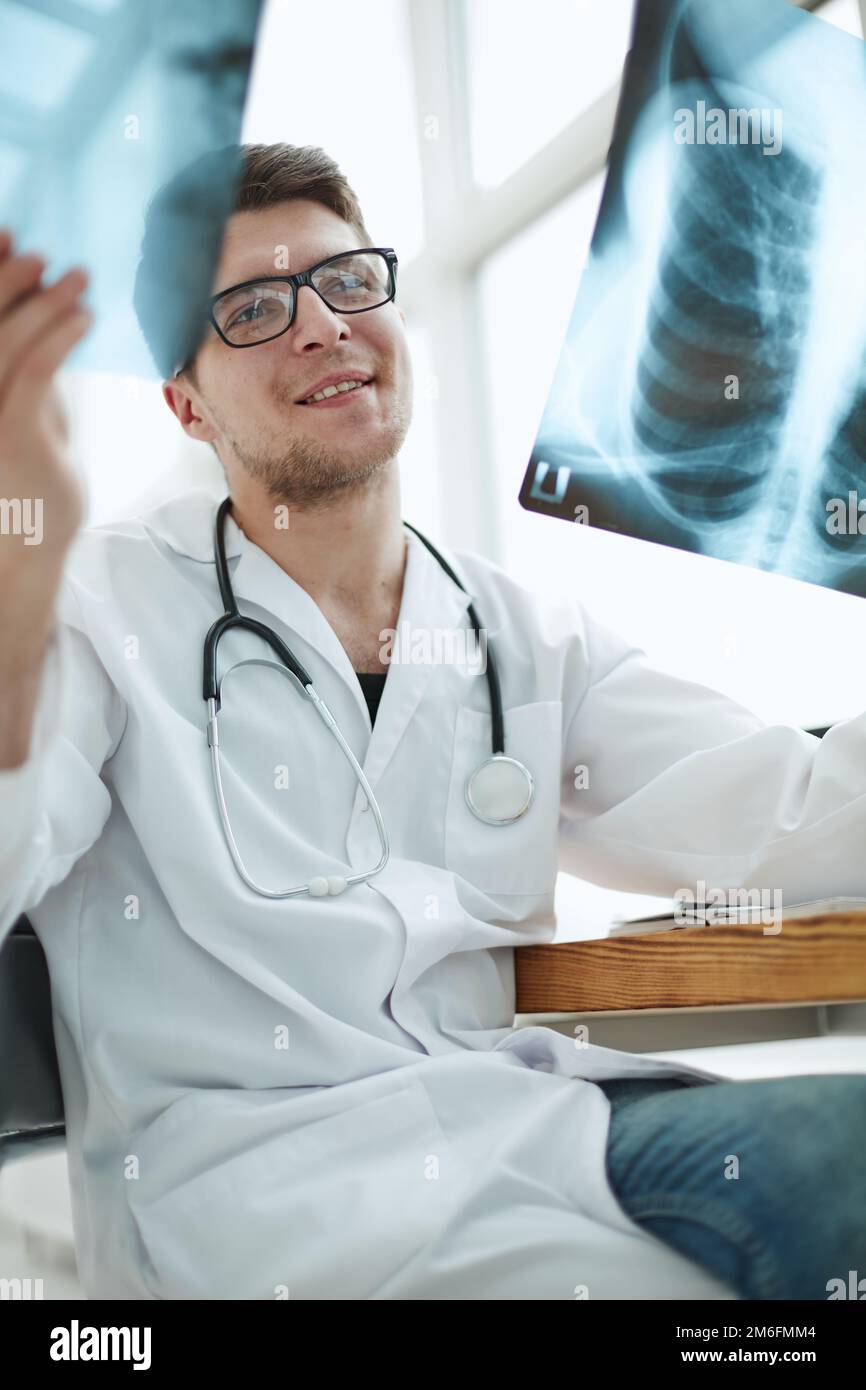Male doctor radiologist examines xrays in a medical office Stock Photo