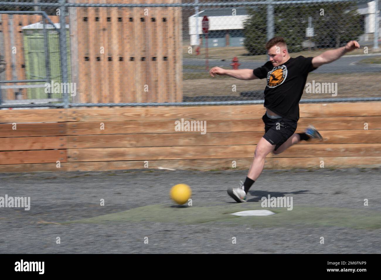 U.S. Coast Guard Petty Officer 3rd class Kimble Peterson plays kickball during a morale event