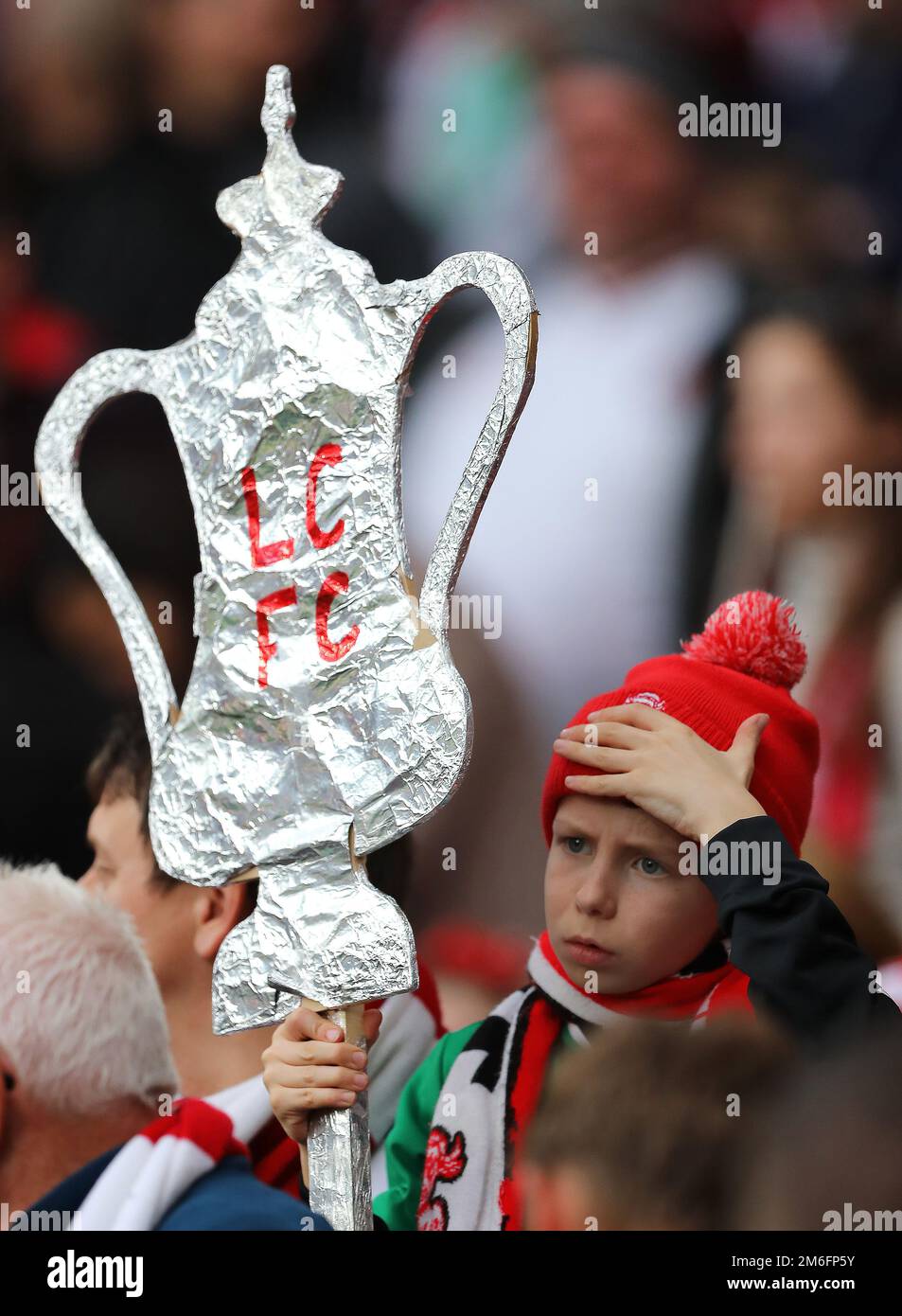 A young Lincoln City fan looks disappointed with a tin foil FA Cup - Arsenal v Lincoln City, The Emirates FA Cup Quarter-final, Emirates Stadium, London - 11th March 2017. Stock Photo