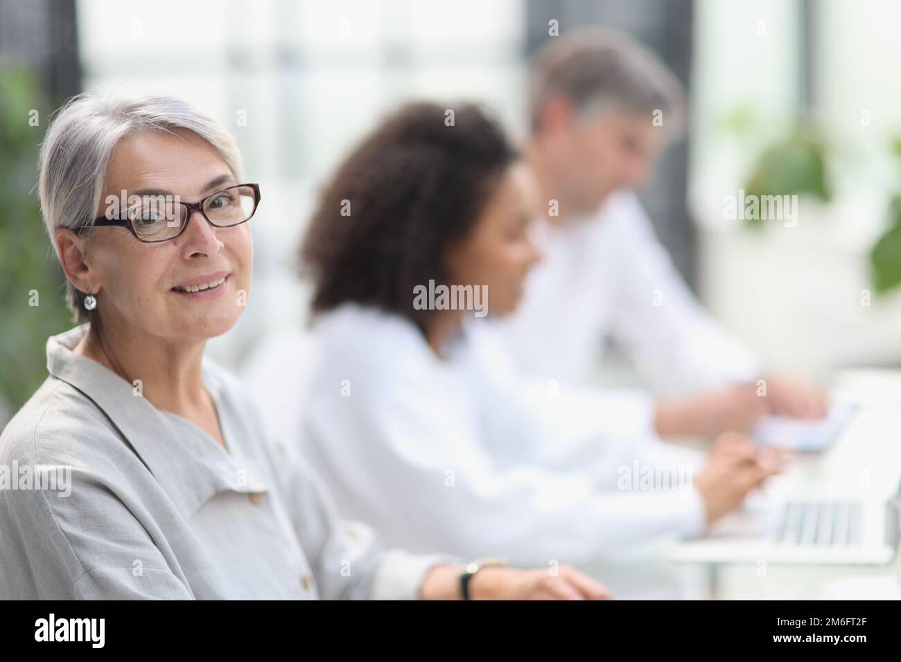 portrait of a mature woman during a break in the office Stock Photo - Alamy