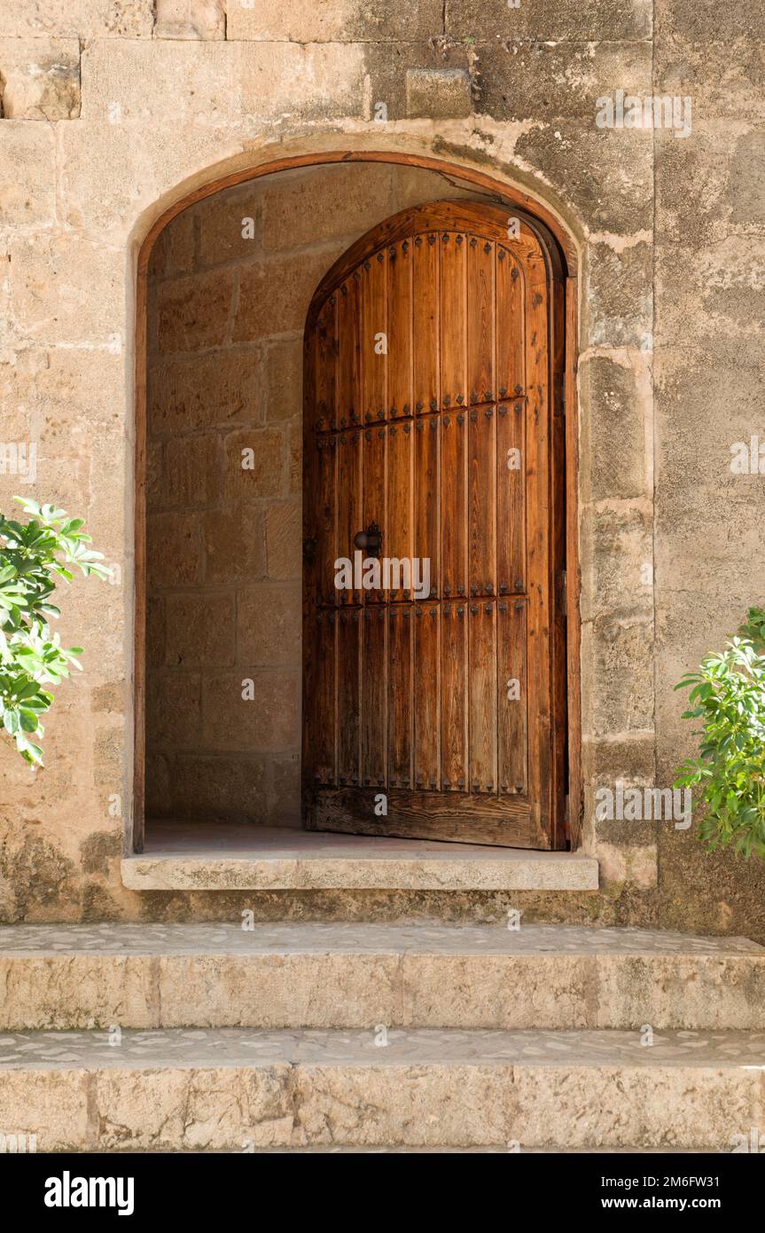 A building with a wooden arched door Stock Photo - Alamy