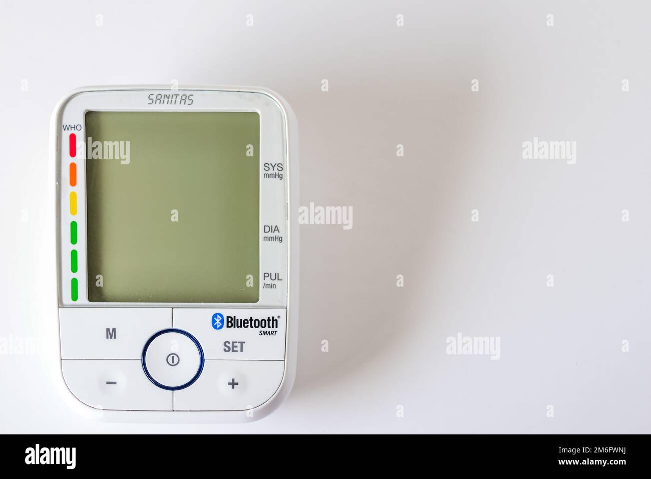A Sanitas brand digital arm blood pressure monitor on a white surface