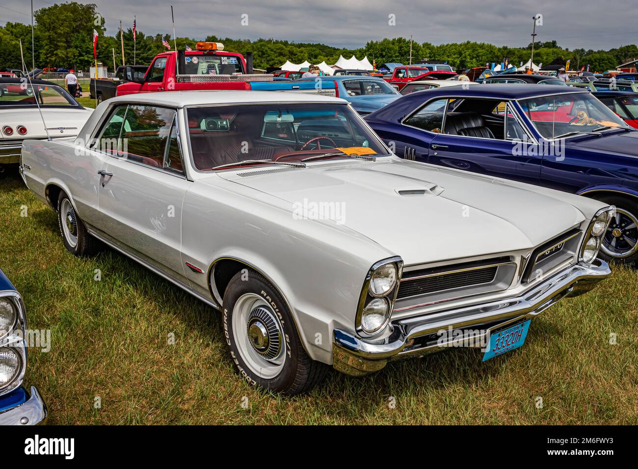Iola, WI - July 07, 2022: High perspective front corner view of a 1965 Pontiac GTO 2 Door Hardtop at a local car show. Stock Photo