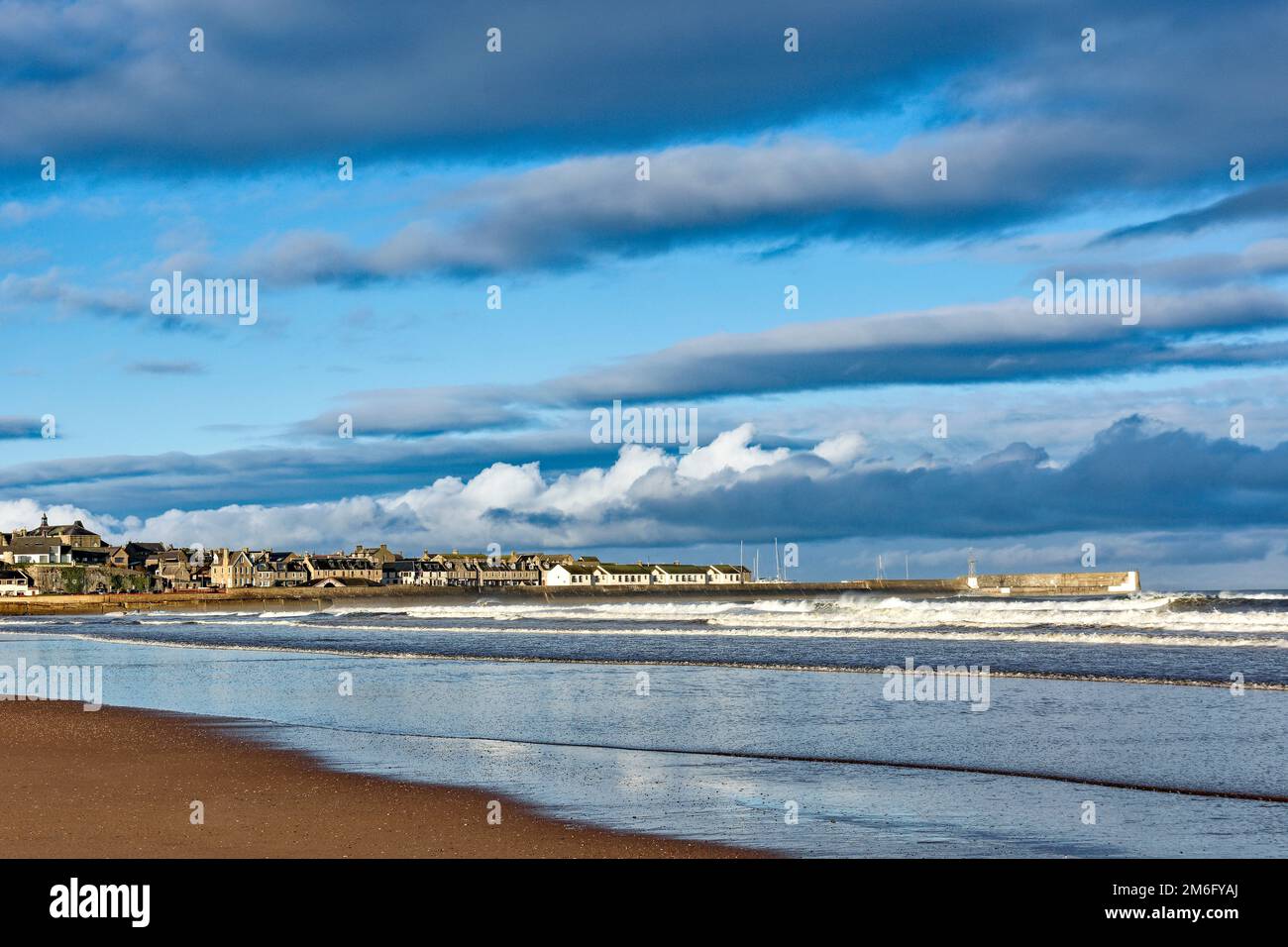Lossiemouth East Beach Moray coast Scotland houses and harbour walls seen from the beach in winter Stock Photo