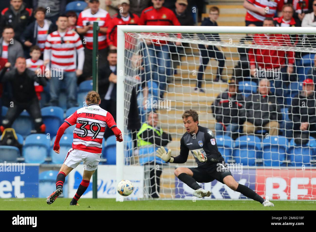 Sam Walker of Colchester United saves to deny Alfie May of Doncaster