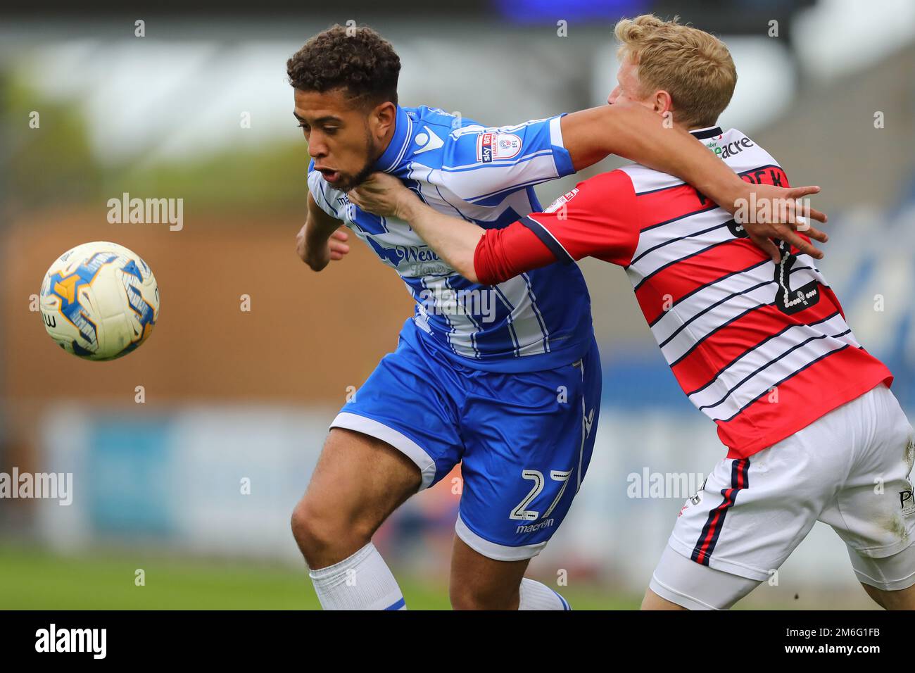 Rekeil Pyke of Colchester United shields the ball rom Craig Alcock of