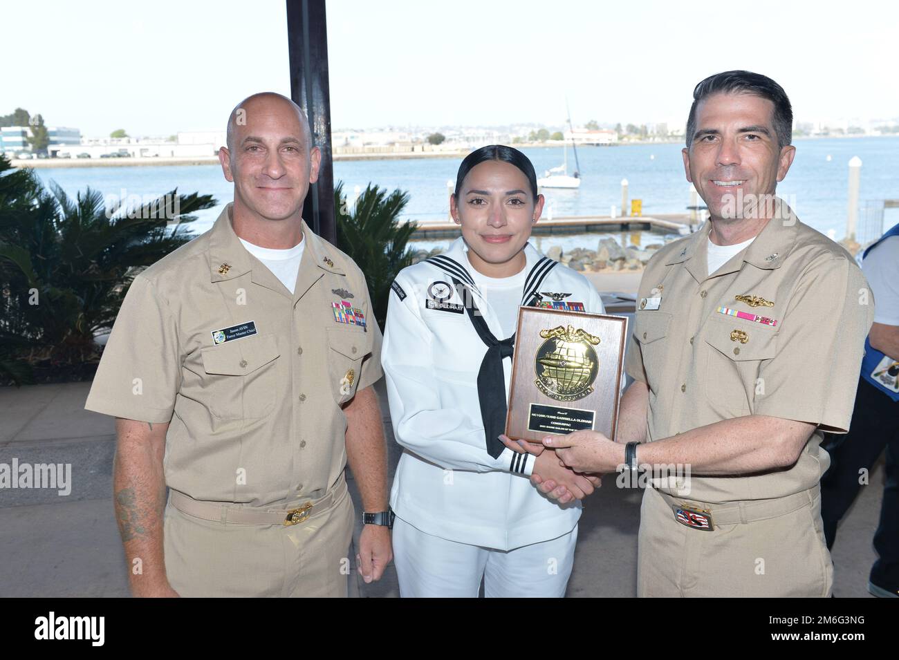 SAN DIEGO-- Capt. J. Patrick Friedman, commander, Submarine Squadron 11 (right) and Submarine Force Pacific Force Master Chief Jason Avin (left) award Navy Counselor 1st class Gabriella Oldham from Naval Ocean Processing Facility, Whidbey Island the Submarine Force Pacific (Sea) Sailor of the year in San Diego. U. S. Navy photo by Mass Communication Specialist First Class Thomas Gooley/ released Stock Photo
