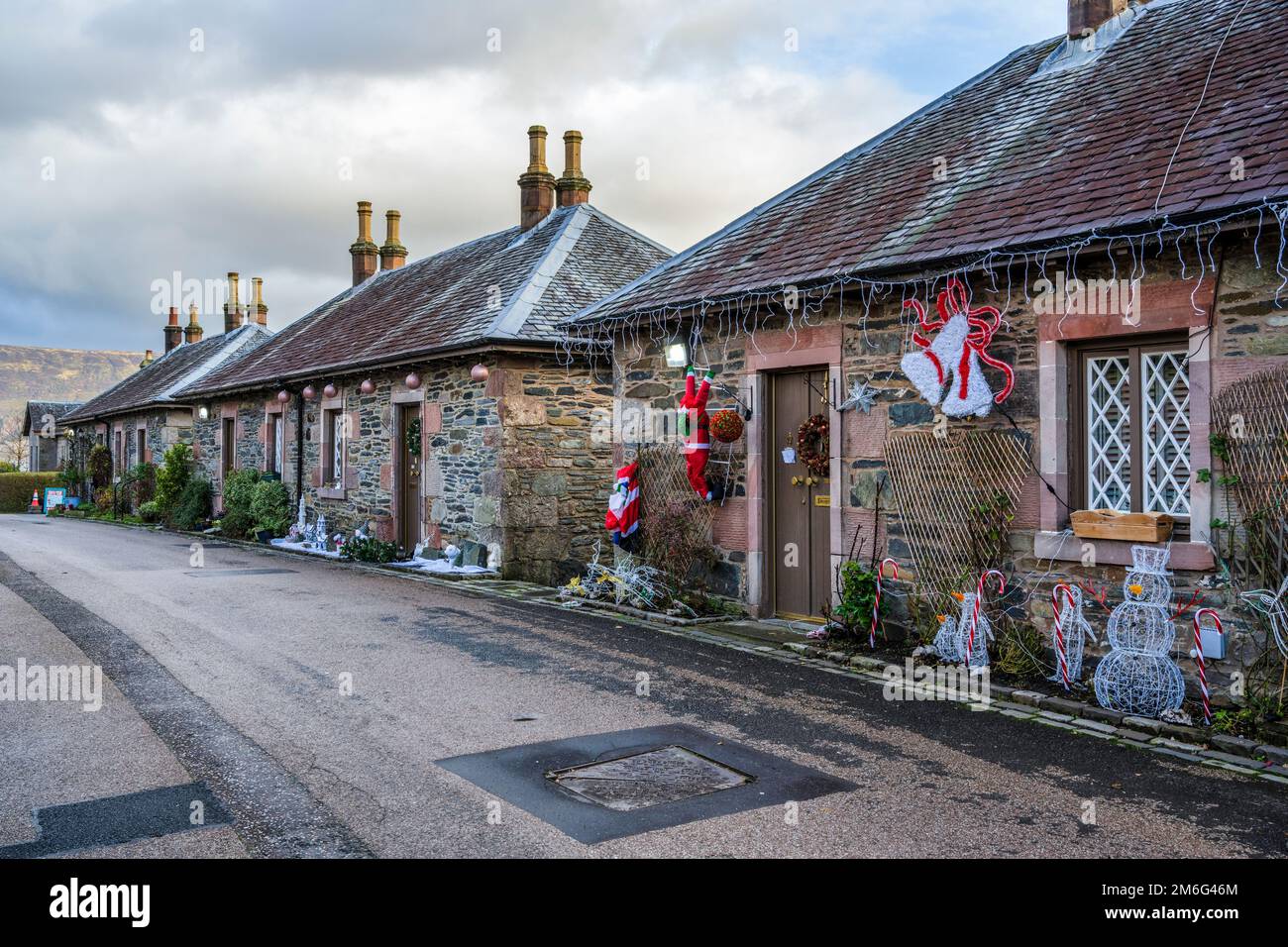 Christmas decorations outside houses along Pier Road in the picturesque village of Luss on Loch Lomond in Scotland, UK Stock Photo