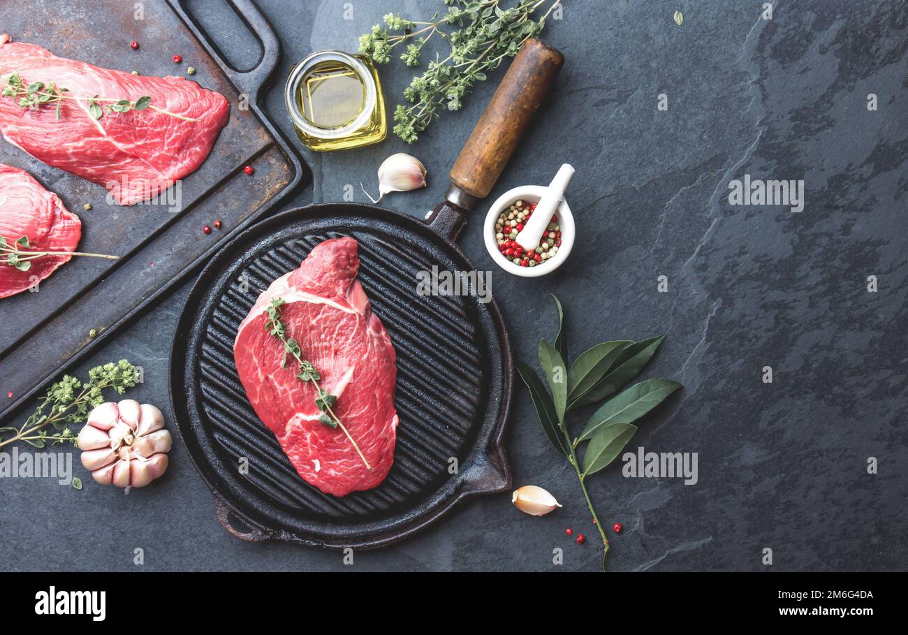 Fresh raw meat. Beef Tenderloin and marbled beef steaks on grill pan ...