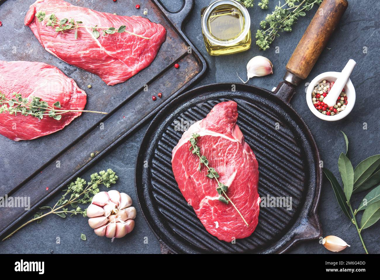 Fresh raw meat. Beef Tenderloin and marbled beef steaks on grill pan ...
