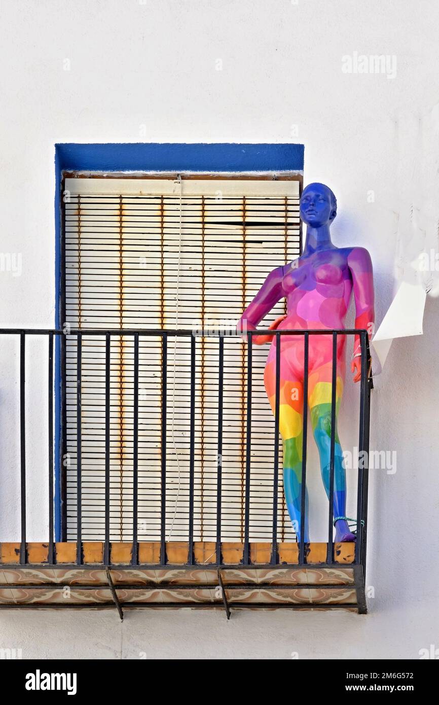 Colorful mannequin in rainbow colors  on a balcony Stock Photo