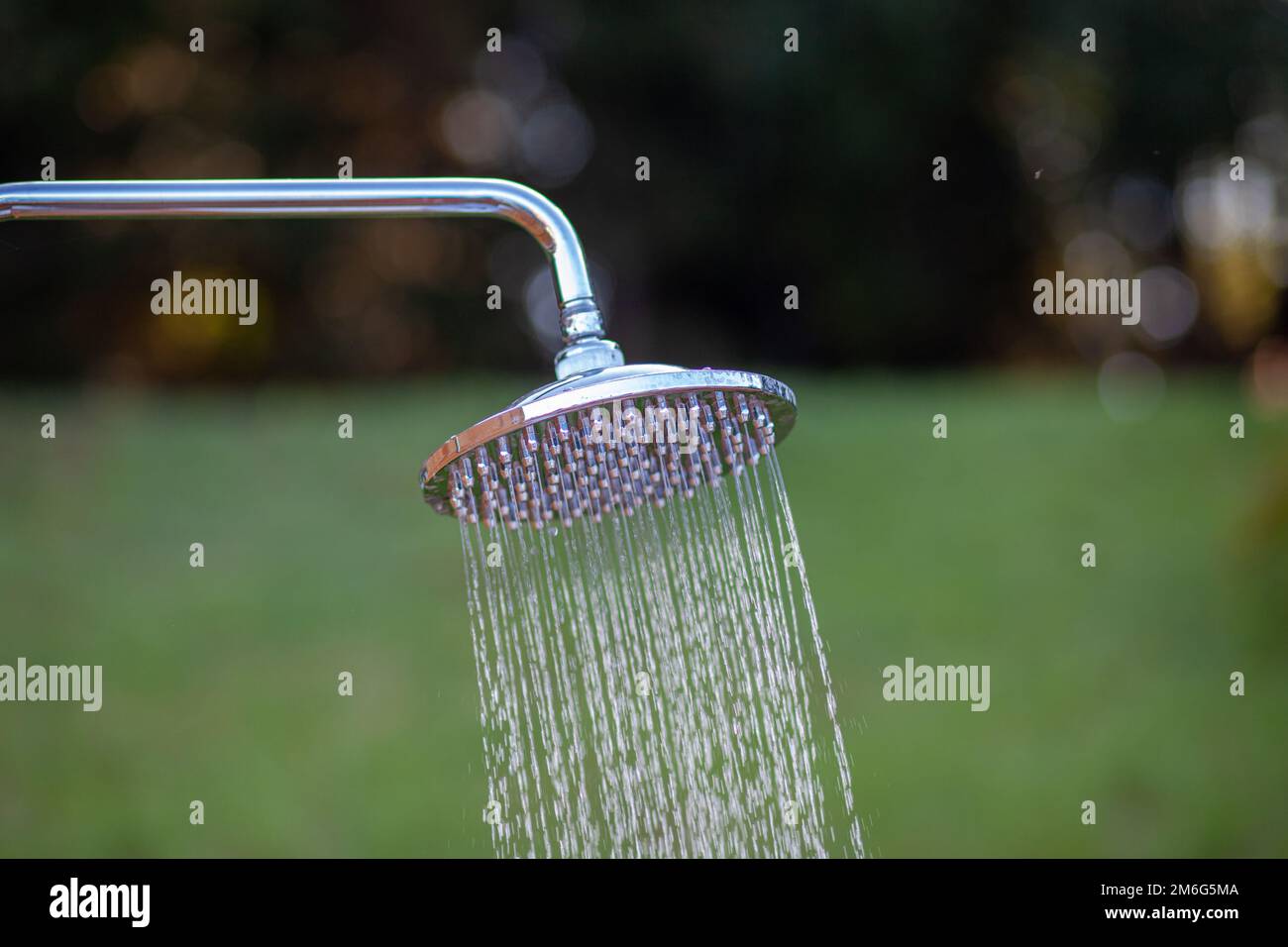 Outdoor shower head stick on the wooden plate pole design for showerin