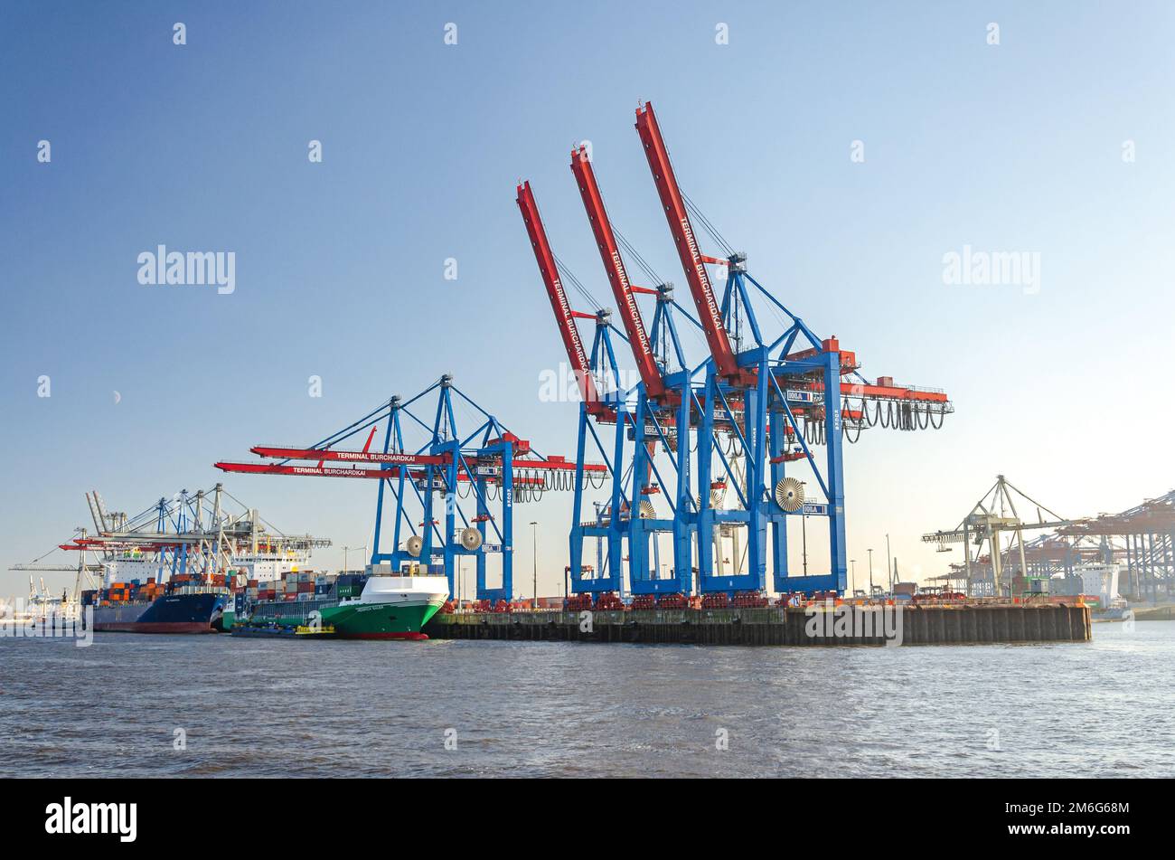 Container vessels and harbour facilities at a the Burchardkai container terminal in the port area of Hamburg, Germany Stock Photo