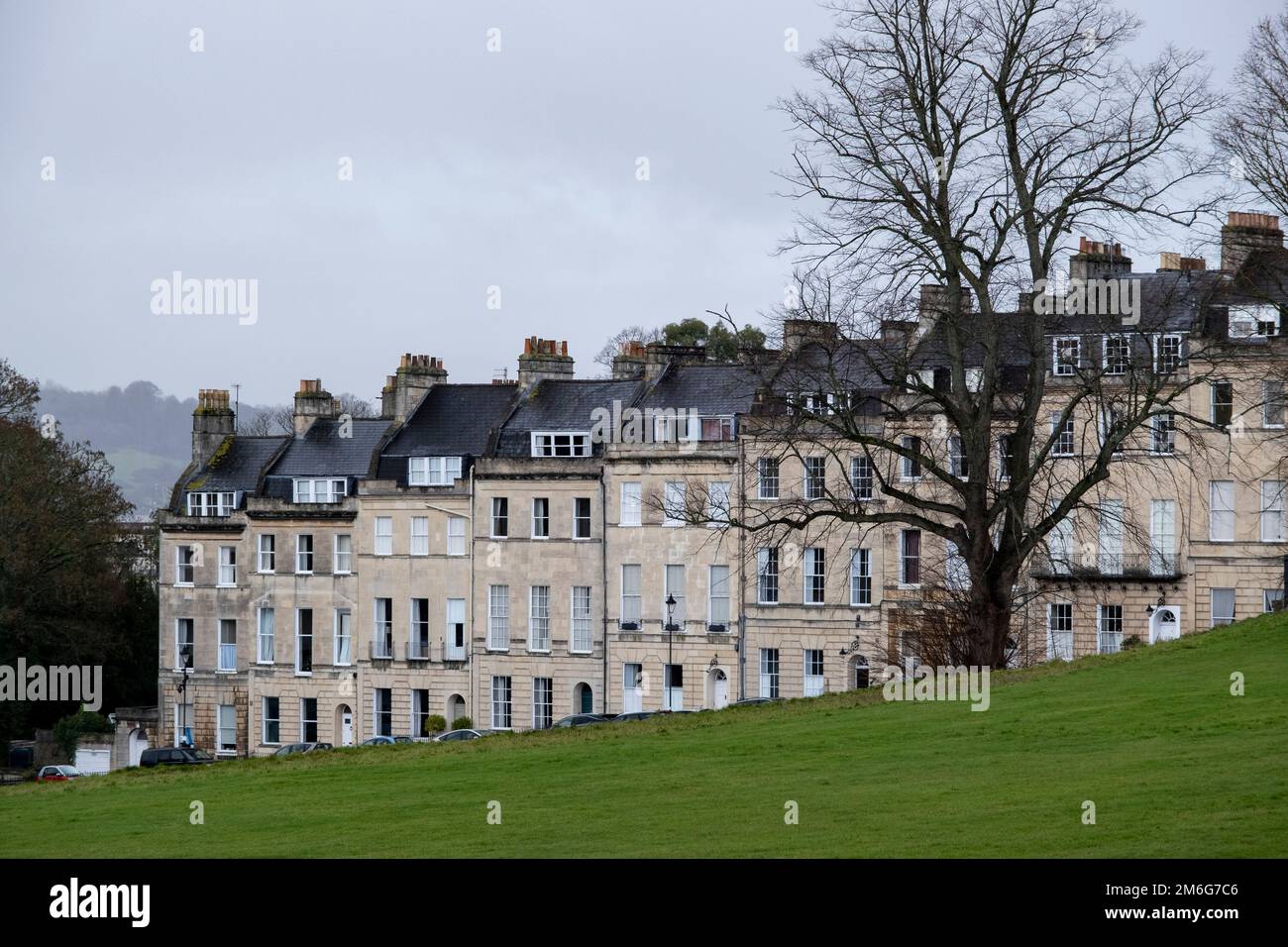 View of terraced homes along the street Marborough Buildings on 27th December 2022 in Bath, United Kingdom. Bath is a city in the county of Somerset, known for and named after its Roman-built baths, and Georgian architecture made from the local honey coloured Bath Stone. The city became a World Heritage Site in 1987, and was later added to the transnational World Heritage Site known as the ‘Great Spa Towns of Europe’ in 2021. Stock Photo
