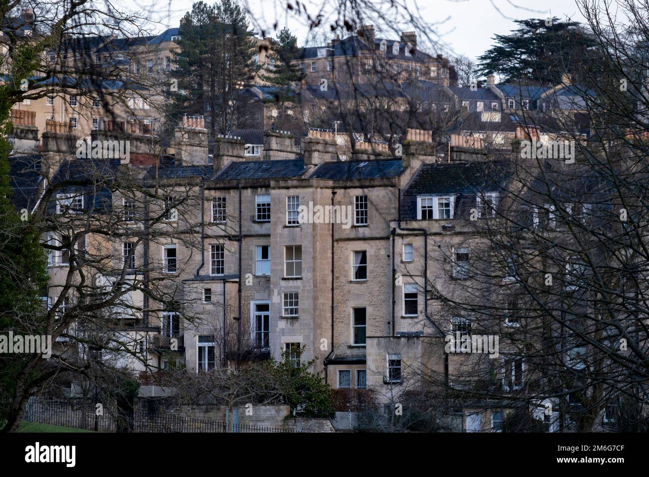 Rooftops and chimneys of Georgian buildings on 29th December 2022 in Bath, United Kingdom. Bath is a city in the county of Somerset, known for and named after its Roman-built baths, and Georgian architecture made from the local honey coloured Bath Stone. The city became a World Heritage Site in 1987, and was later added to the transnational World Heritage Site known as the ‘Great Spa Towns of Europe’ in 2021. Stock Photo