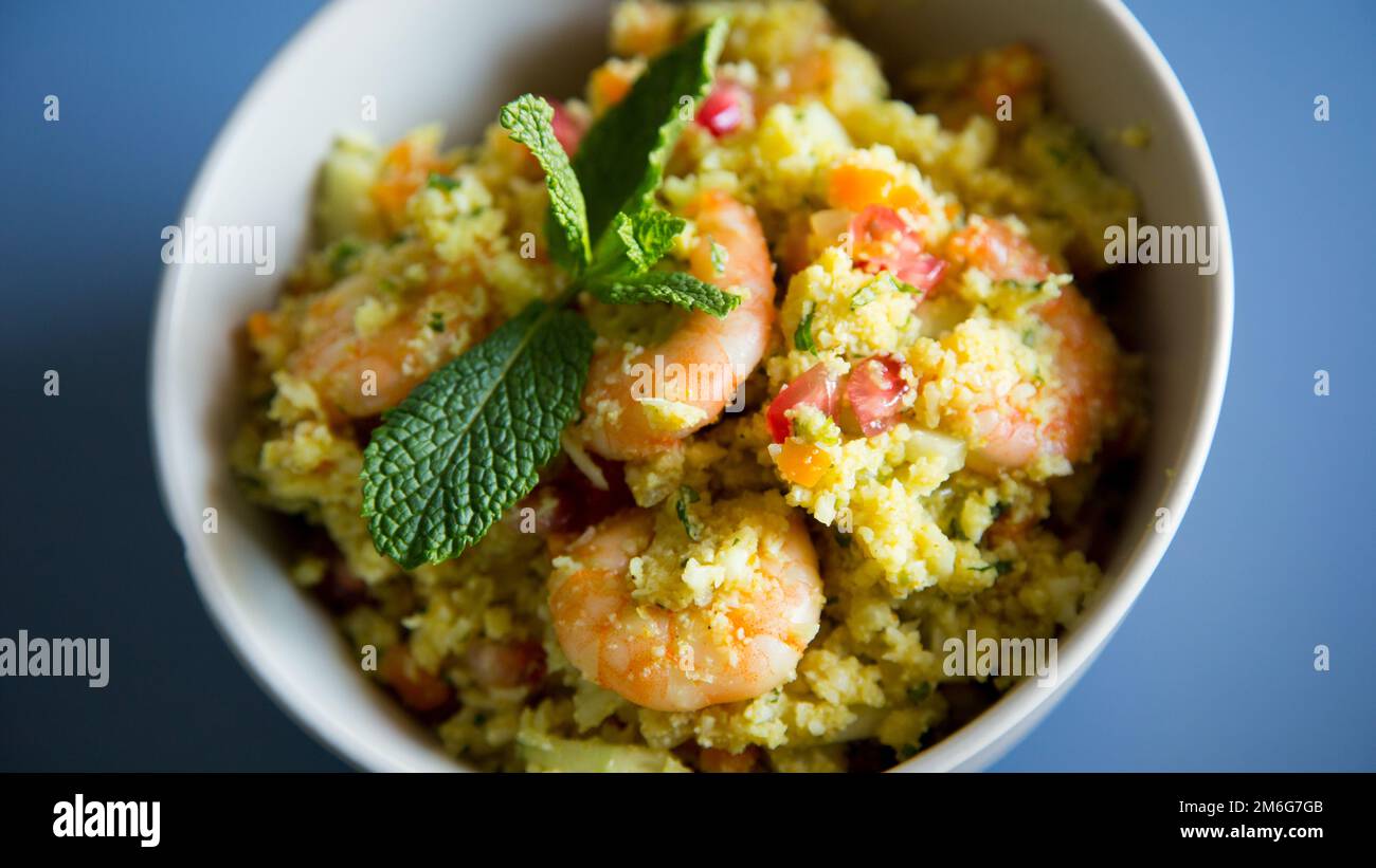 Fake Risotto with shredded cabbage and curry prawns Stock Photo - Alamy