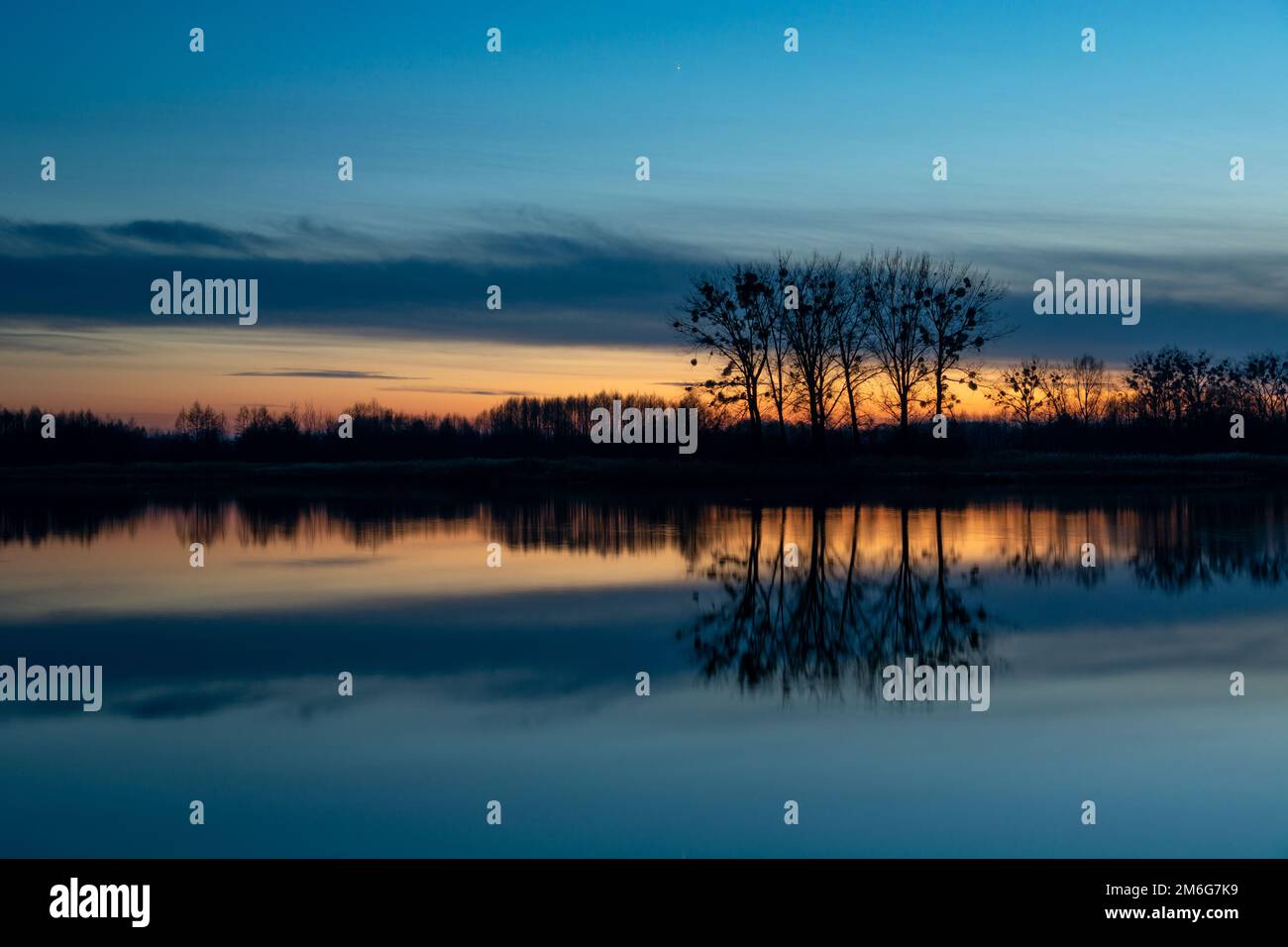 Pond trees reflection water sunset sky silhouette hi-res stock ...