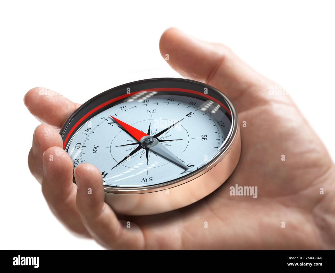 Hand holding a compass over white background. Strategic orientation or direction concept. Stock Photo