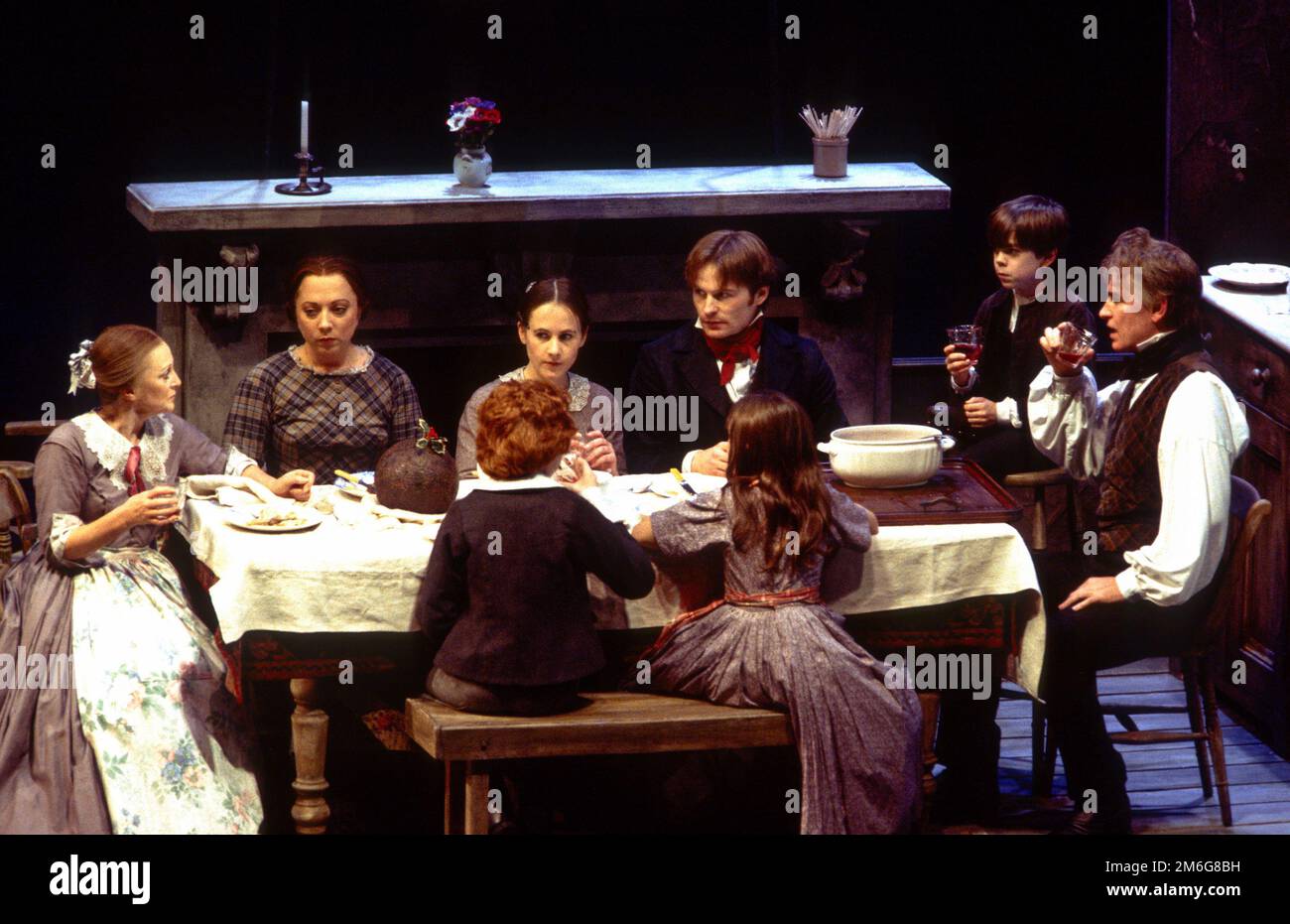 the Cratchit Christmas dinner, l-r: Polly James (Mrs Cratchit), Sara Weymouth (Martha), Vicky Blake (Belinda), Roger Moss (Peter), Steven Geller (Tiny Tim), Paul Greenwood (Bob Cratchit) in A CHRISTMAS CAROL by Charles Dickens at the Royal Shakespeare Company (RSC), Barbican Theatre, Barbican Centre, London EC2  28/11/1994   adapted by John Mortimer  music: Nigel Hess  set design: John Gunter  costumes: Deirdre Clancy  lighting: Nigel Levings  choreography: Lindsay Dolan  director: Ian Judge Stock Photo