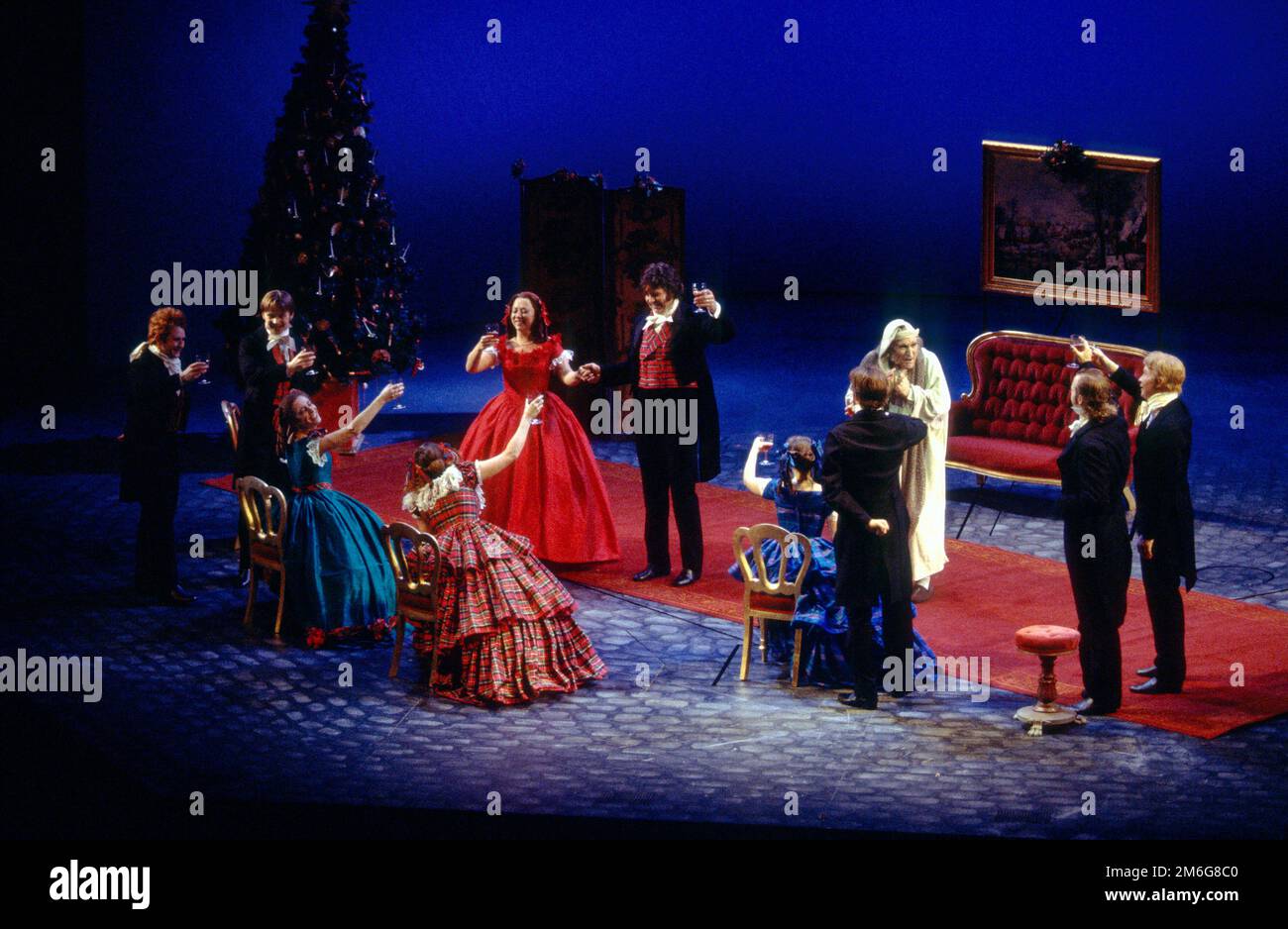 centre, l-r: Sara Weymouth (Fred's wife), Philip Quast (Fred), Clive Francis (Ebenezer Scrooge) in A CHRISTMAS CAROL by Charles Dickens at the Royal Shakespeare Company (RSC), Barbican Theatre, Barbican Centre, London EC2  28/11/1994   adapted by John Mortimer  music: Nigel Hess  set design: John Gunter  costumes: Deirdre Clancy  lighting: Nigel Levings  choreography: Lindsay Dolan  director: Ian Judge Stock Photo