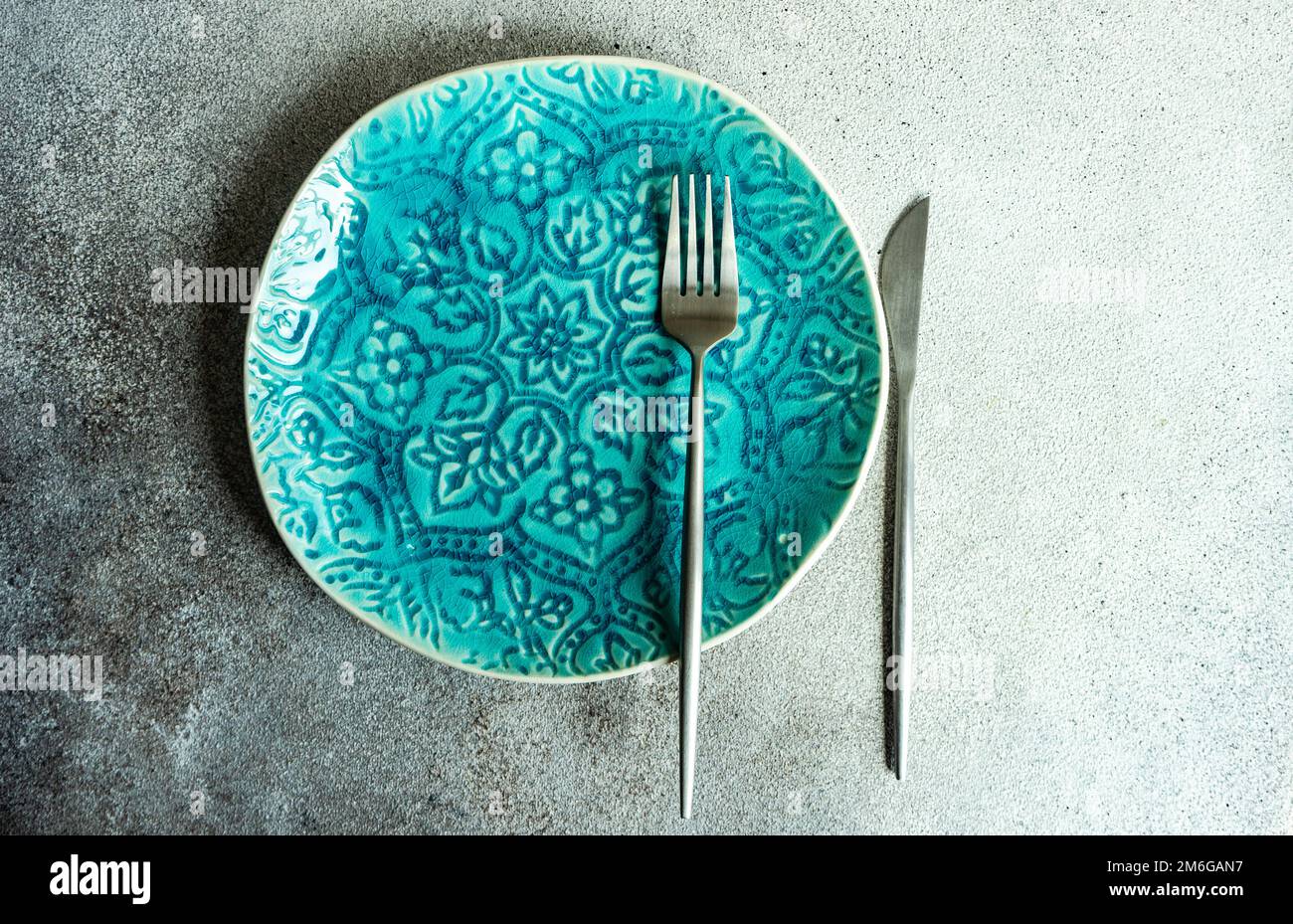 Minimalistic table setting with plate and cutlery Stock Photo