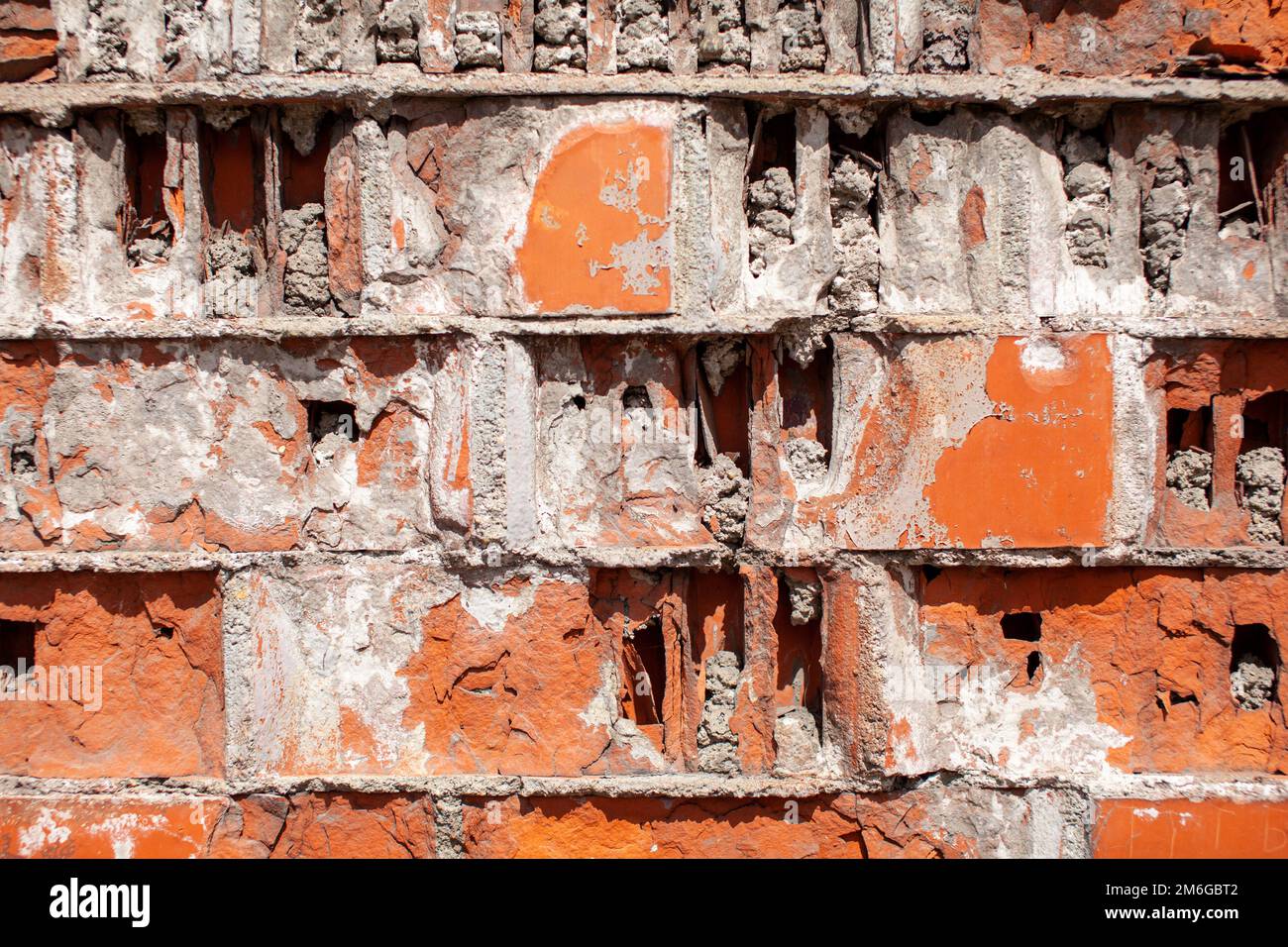 Old red brick wall. The bricks are laid in rows. Grunge stone texture. Stock Photo