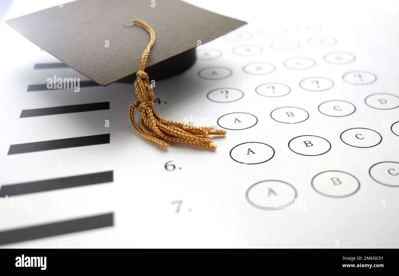 Multiple choice exam answer bubbles and mini graduation cap Stock Photo