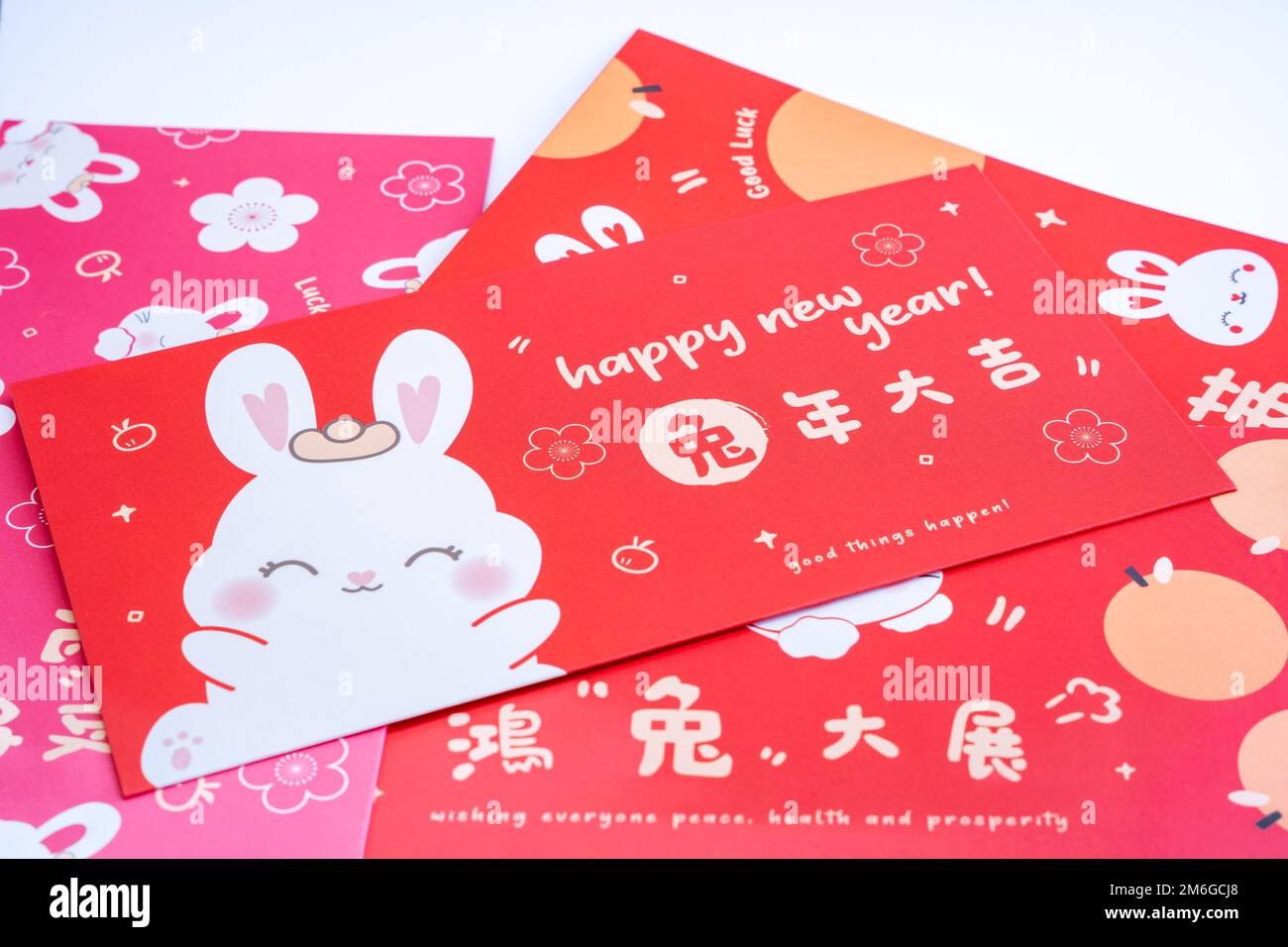 Chinese red envelope. Chinese new year concept background . Translation on red envelope: 'Happy New Year of Rabbit' Stock Photo