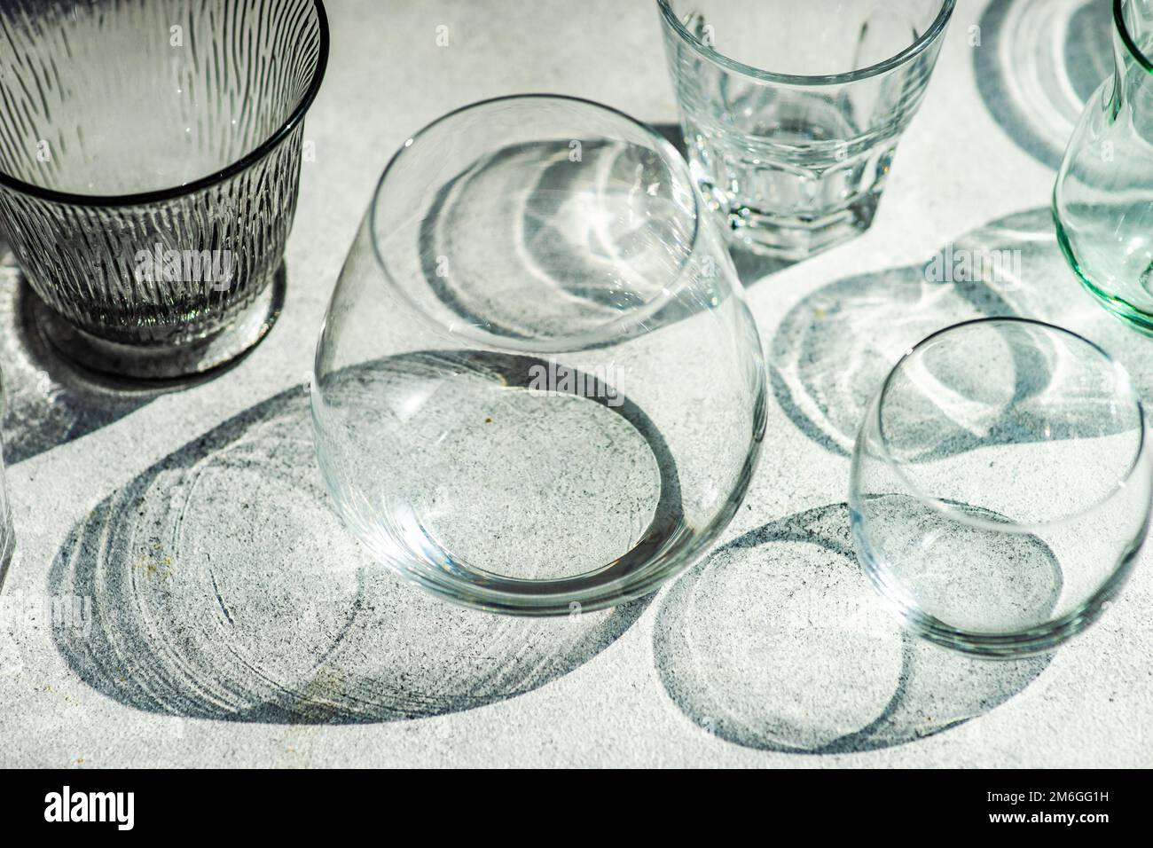 Variety empty glasses in sunny day Stock Photo