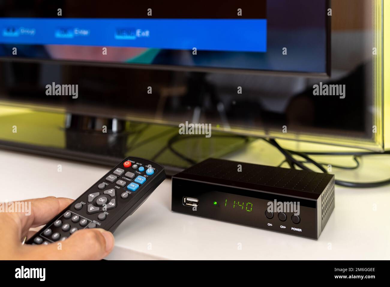 Digital decoder with remote control and television monitor. Stock Photo